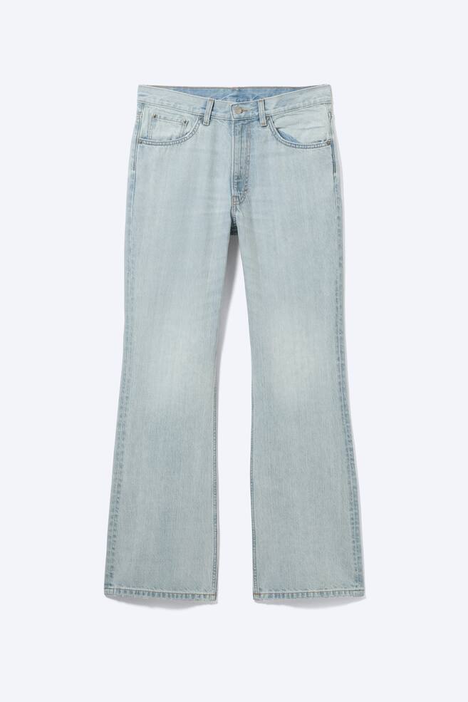 A pair of light wash jeans is presenting a front view, featuring a mid-rise waist, a relaxed fit, and a bootcut leg. The jeans are displaying a subtle streaky denim texture, two front pockets, a coin pocket, and a zip fly fastening. - 1