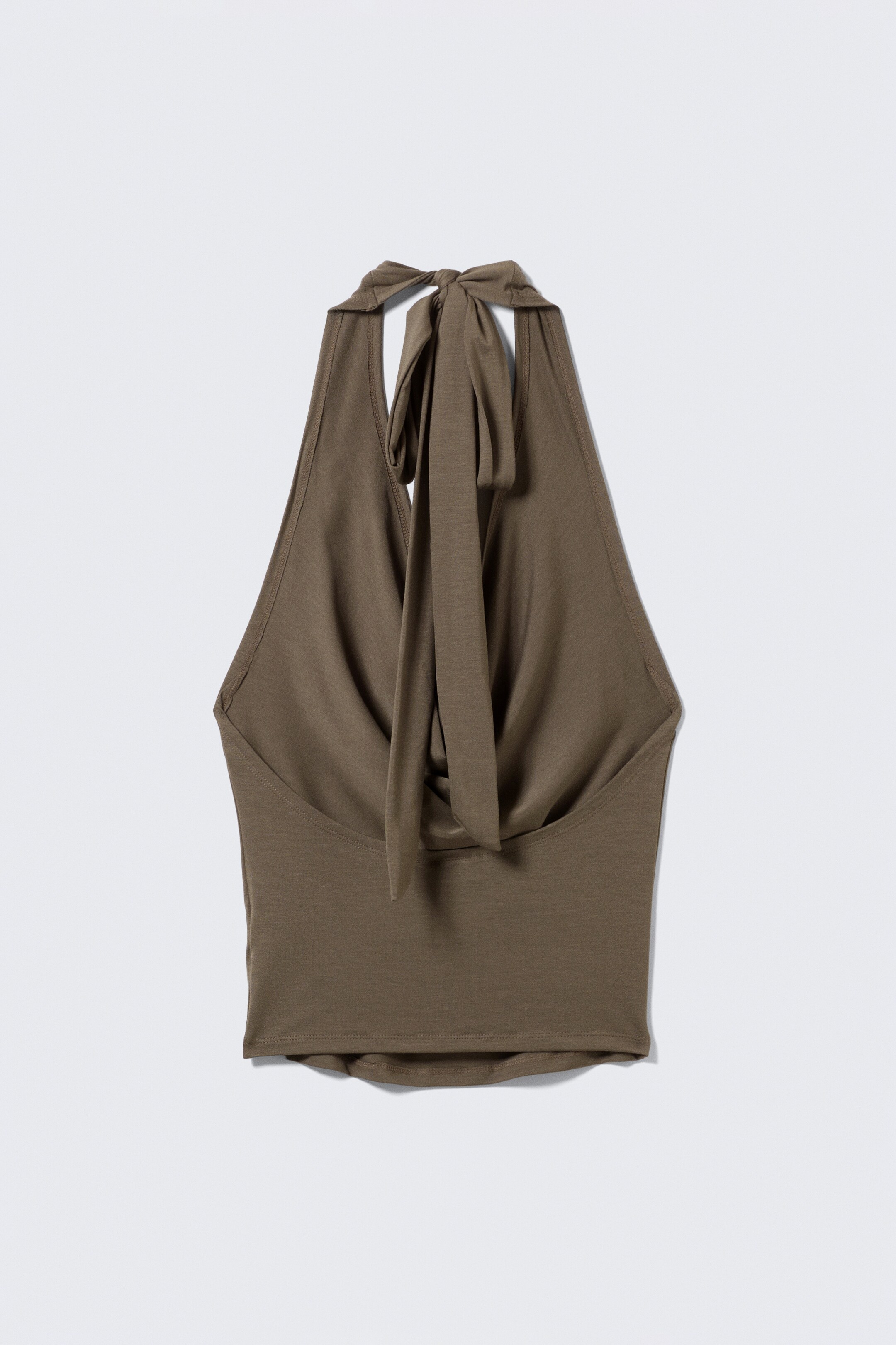 View larger image: An olive green sleeveless halter top is showing its back, with long, double-layered straps tying in a bow at the neck. The top is featuring a soft, fluid drape.