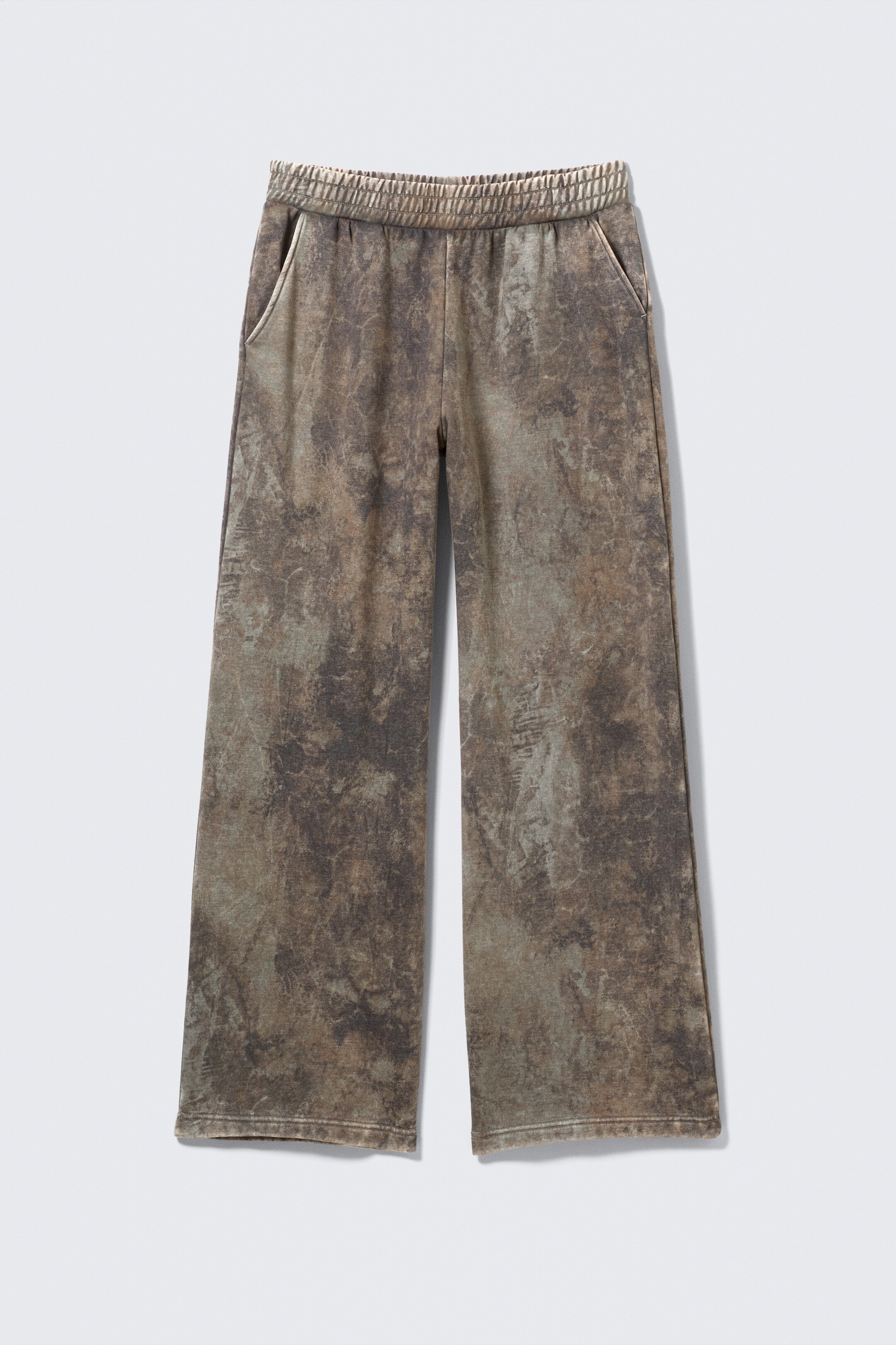 View larger image: Front view of wide-leg pants featuring a mottled brown, grey, and olive green pattern. The pants are designed with an elasticized ribbed waistband and side slit pockets that are accented with lighter trim.