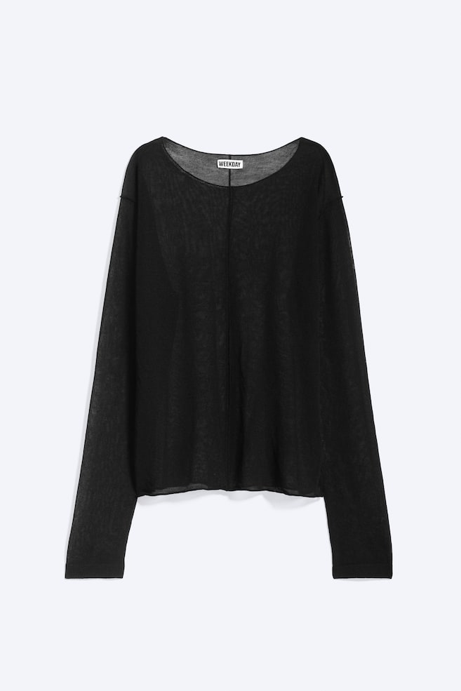 Se muestra un jersey de punto negro semitransparente desde el frente, con un diseño de corte holgado, escote amplio y hombros caÃdos. La prenda de manga larga presenta una costura vertical que recorre el centro delantero y puños de canalé sutiles. - 1