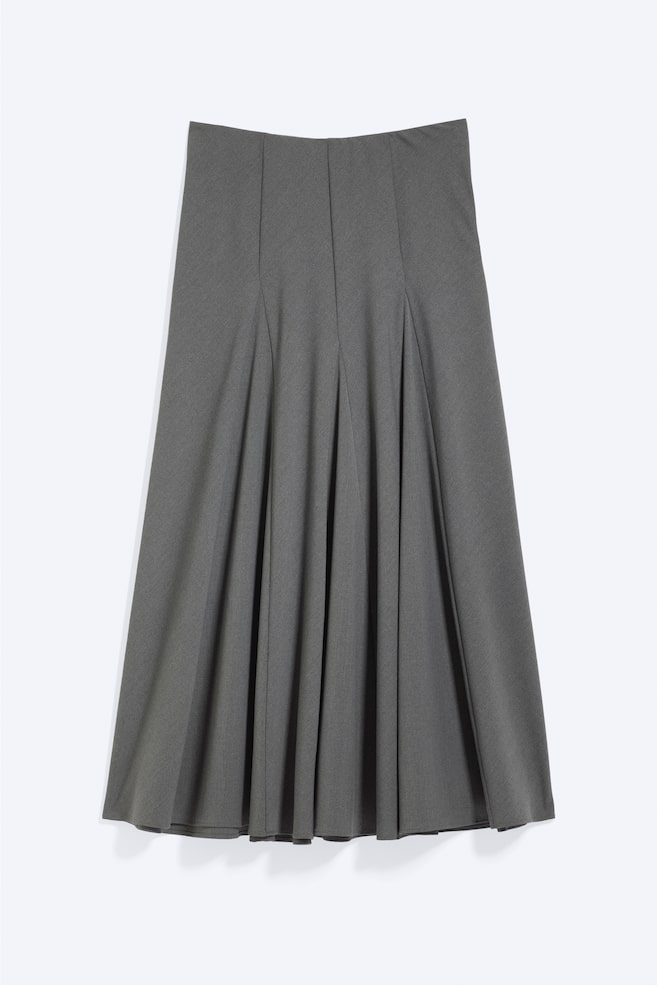 A grey skirt is displayed front-on, featuring a flat, high-waisted design that transitions into knife pleats extending to the hem, creating an A-line silhouette. - 1