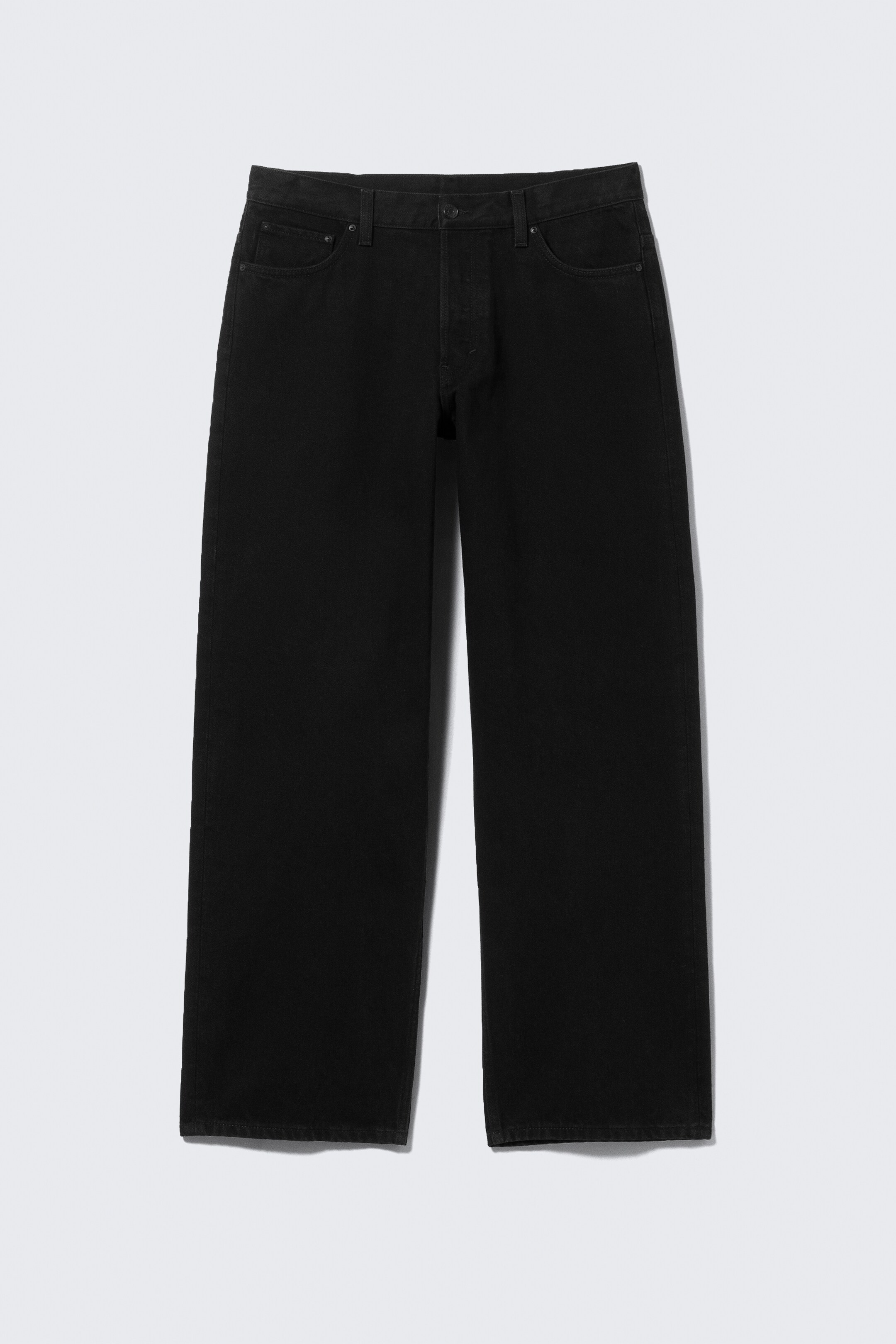 Visualizza immagine più grande: Pantaloni in denim nero a gamba larga sono mostrati piatti dal davanti. Presentano una chiusura con bottoni, due tasche frontali a cucchiaio e una piccola tasca per le monete.