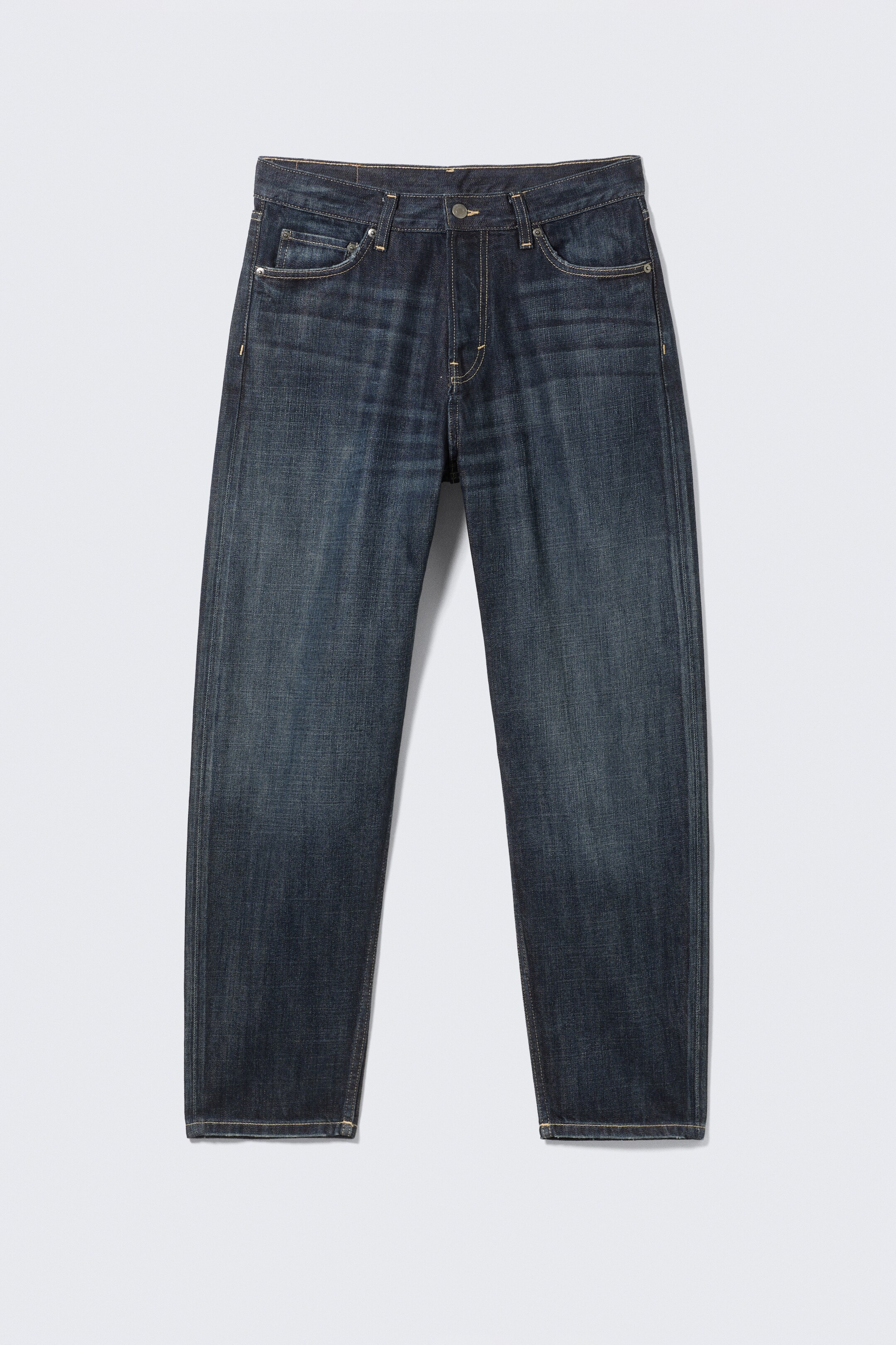 View larger image: A pair of dark blue wash jeans is presented as FRONT, featuring a relaxed fit with a tapered leg. They are showcasing visible front and coin pockets, a button fly closure, and contrast stitching throughout.