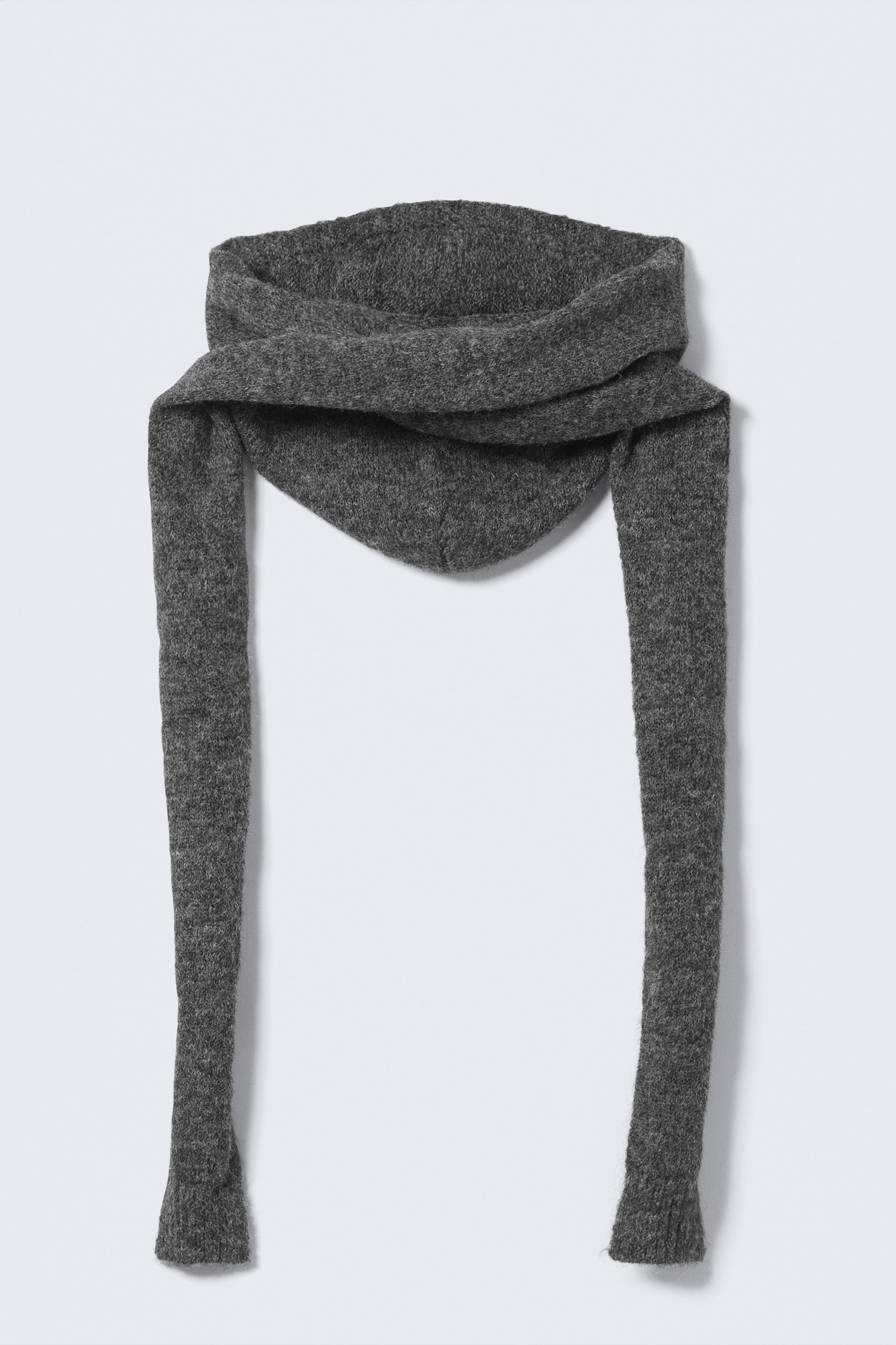 View larger image: A dark gray knitted garment is featuring a draped, cowl-like upper section that narrows to a triangular point at the center front, from which two long, narrow sleeves are extending downwards, each ending in a ribbed cuff.