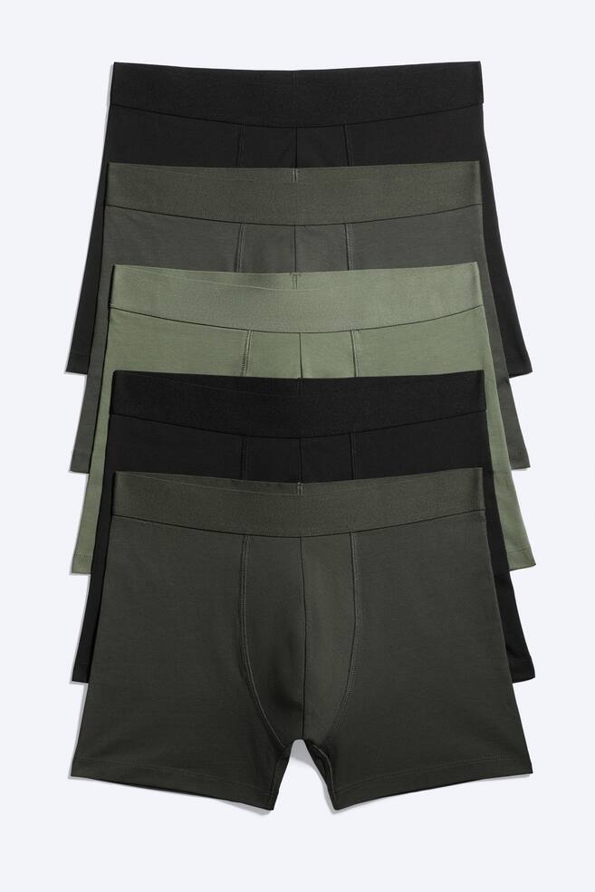Five pairs of boxer briefs are neatly stacked in alternating black and olive green colours, with each pair featuring an elastic waistband and a contoured front panel. - 1