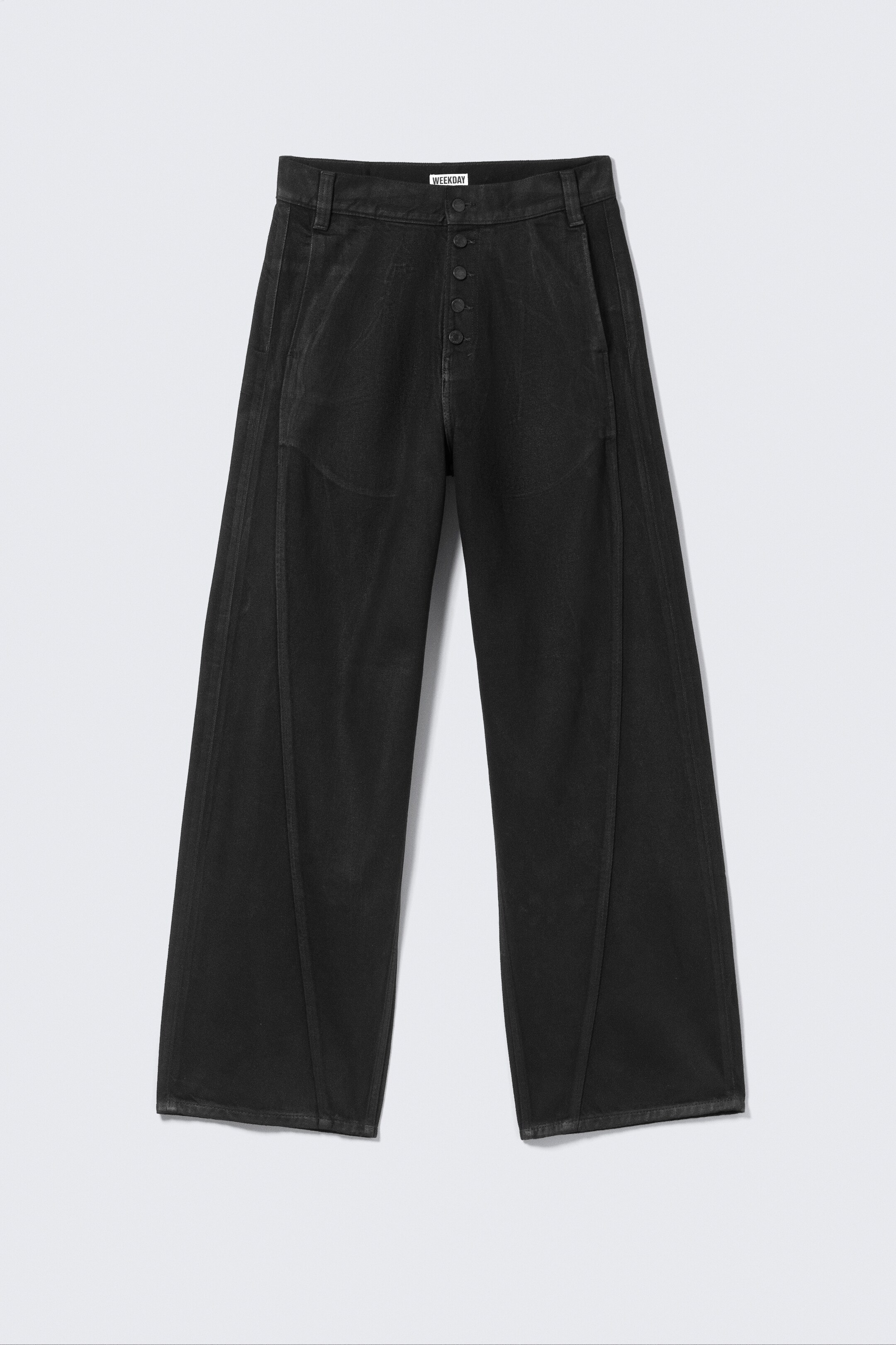 View larger image: Black wide-leg pants are being displayed from the FRONT. They are featuring a five-button fly closure and a waistband with belt loops. Prominent vertical seams are running down the front of each leg, creating a paneled design, and the fabric is exhibiting a washed black appearance.