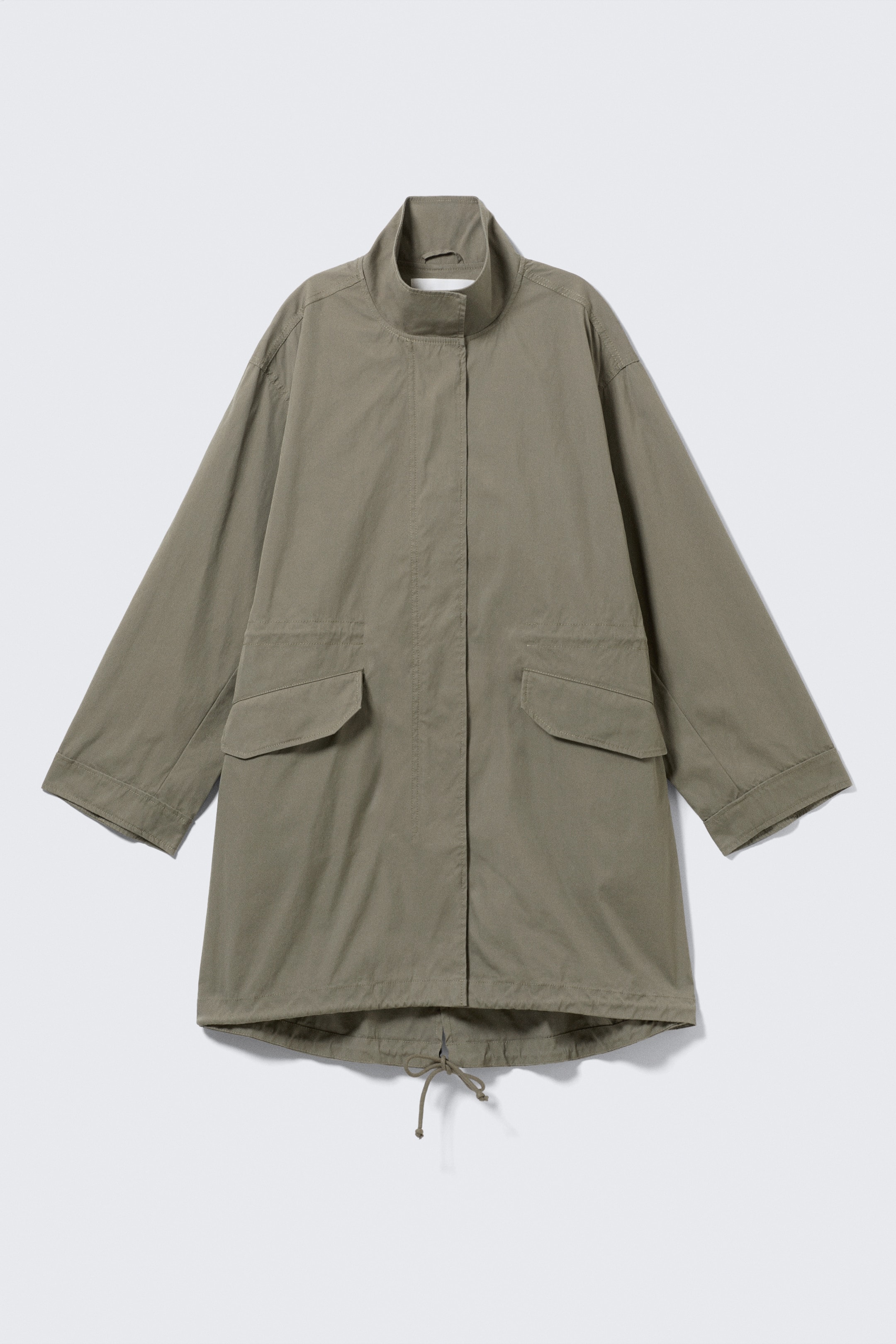 View larger image: A front view of an olive green parka jacket featuring a stand-up collar, a concealed front placket, two flap pockets, and a drawstring hem at the bottom.