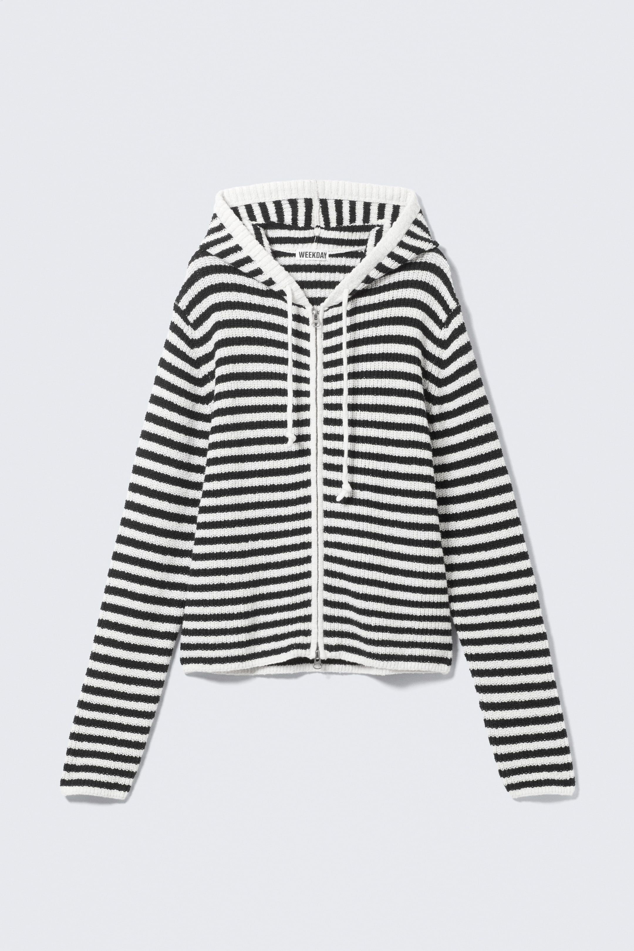 View larger image: A black and white striped full-zip hoodie is displayed from the front, featuring a ribbed knit texture, a drawstring hood, a full-length front zip, and ribbed cuffs and hem.