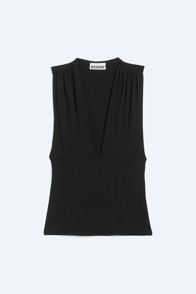 A black sleeveless top is shown from the front, featuring a deep, plunging V-neckline and gathered detailing at the shoulders. The top is designed with a fitted bodice showcasing vertical panel seams and a straight hem. - 1