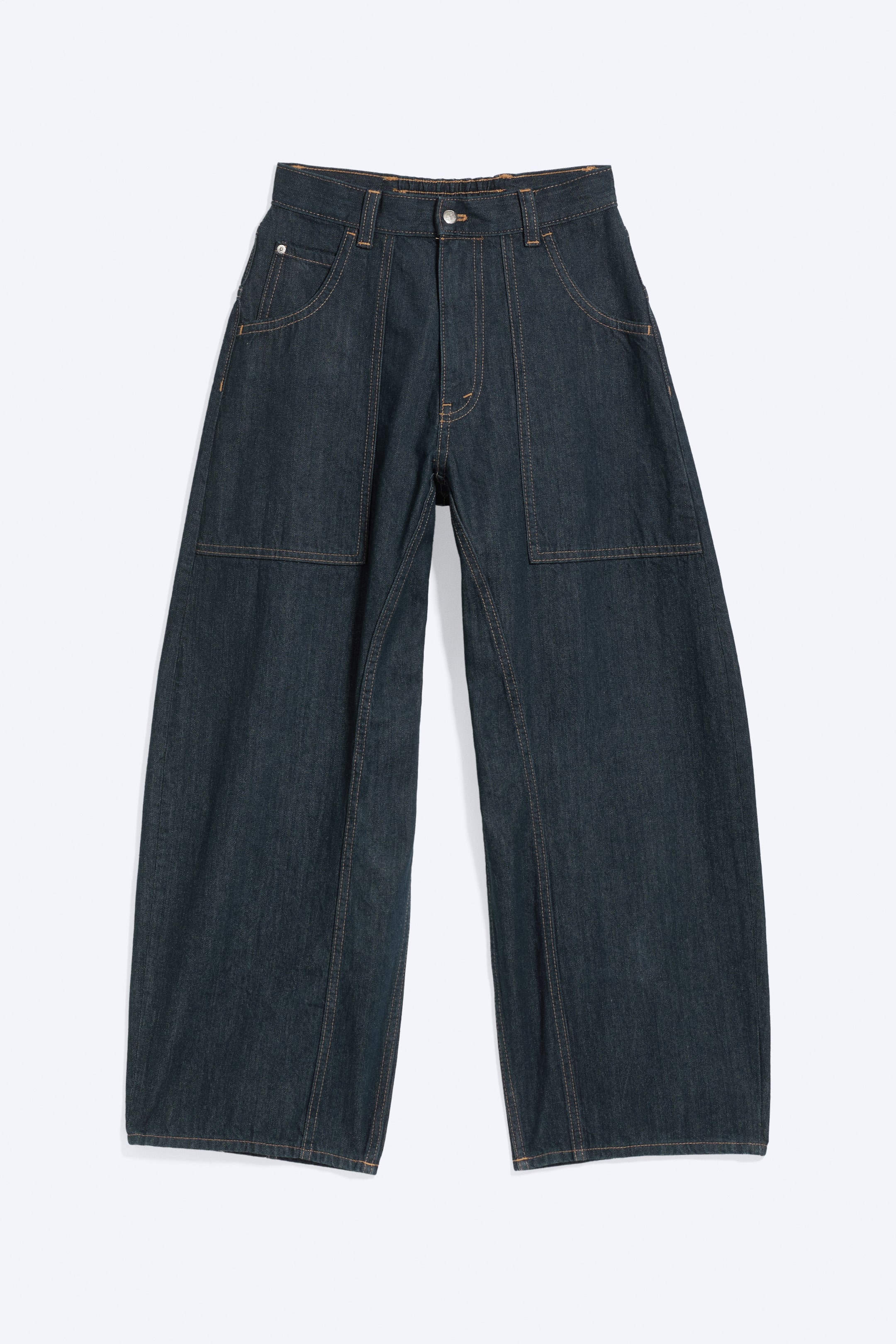 View larger image: The dark indigo barrel-leg jeans are showcased from a front perspective, featuring a flat front waistband with a button fastening, zip fly, and belt loops, all highlighted with prominent orange contrast stitching. They display two rounded-entry front pockets with rivets and two large rectangular patch pockets on the thighs, contributing to their wide and relaxed fit.
