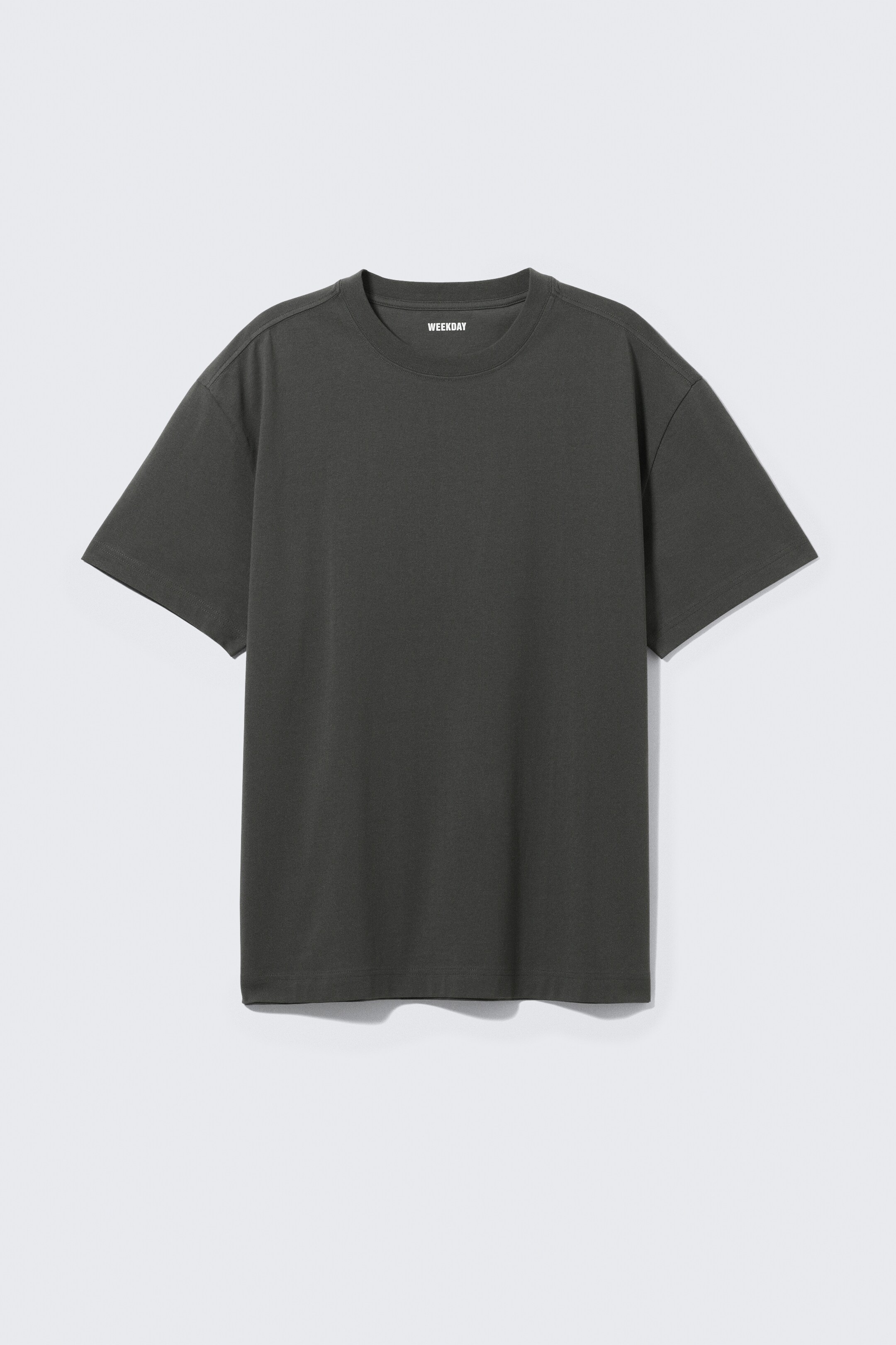 View larger image: A dark gray oversized T-shirt is being shown from the front, presenting an extra loose fit with a ribbed crew neck, dropped shoulders, and wide sleeves in a smooth, heavyweight fabric.