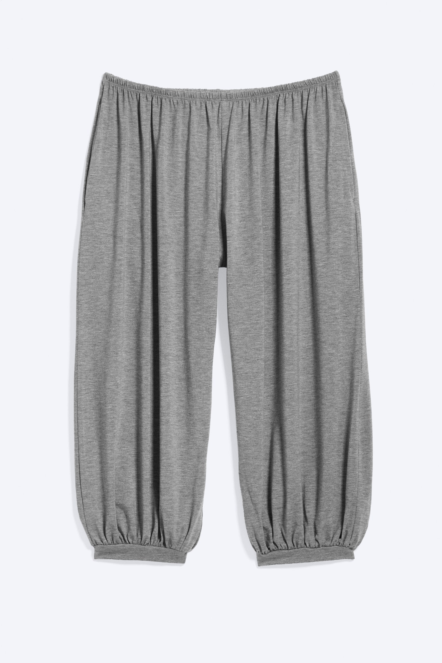 I pantaloni capri grigi presentano una vestibilità comoda con una cintura elasticizzata, polsini arricciati a metà polpaccio e tasche laterali con cuciture visibili. - 1