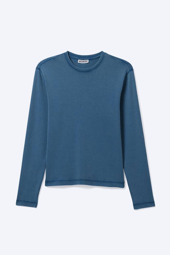 A blue long-sleeved T-shirt is presented from the front, showcasing a ribbed texture on its main body and a slim silhouette. It is designed with a crew neckline, and flatlock stitching is visible along the shoulders, cuffs, and hem. - 1