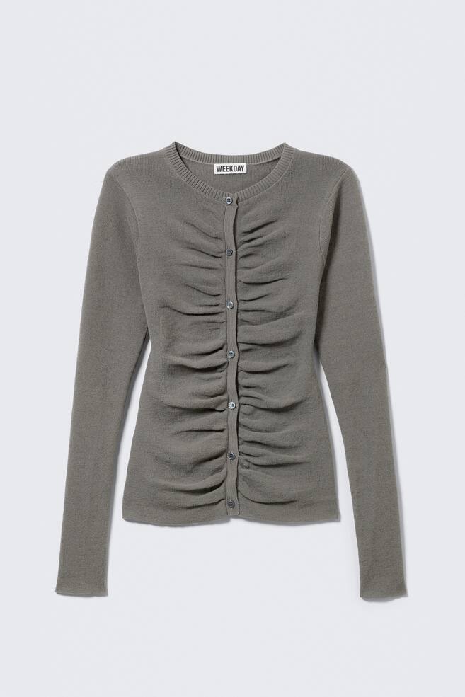 A grey cardigan is shown FRONT, featuring a ribbed crew neck, long sleeves, and a full button-front fastening with small grey buttons. The front panels are ruched vertically, creating a gathered texture down the centre. - 1