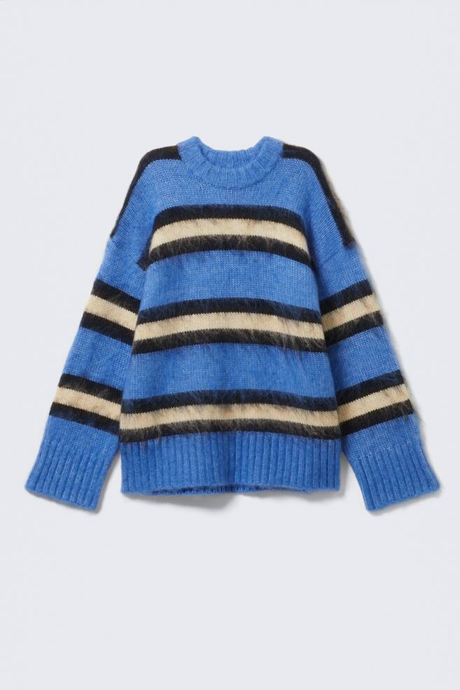 A front view of a blue sweater is featuring horizontal black and beige fuzzy stripes, a ribbed crew neck, ribbed cuffs, and a ribbed hem. - 1