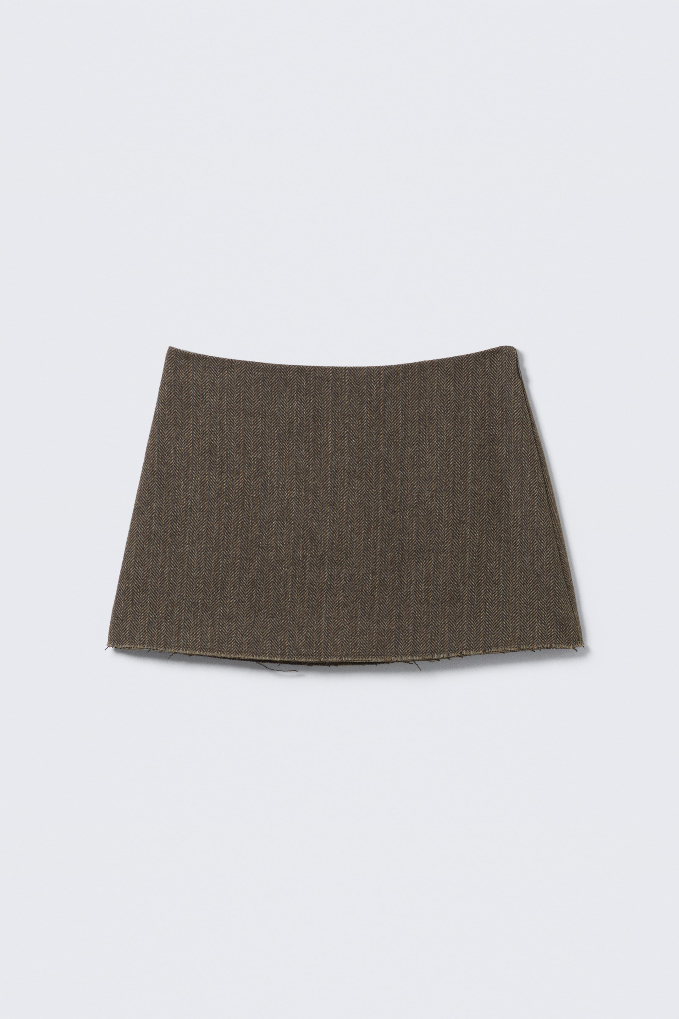 View larger image: A fabric swatch is featuring a dark brown herringbone weave. Its top edge is gently curving, and its bottom edge is showing a raw finish.