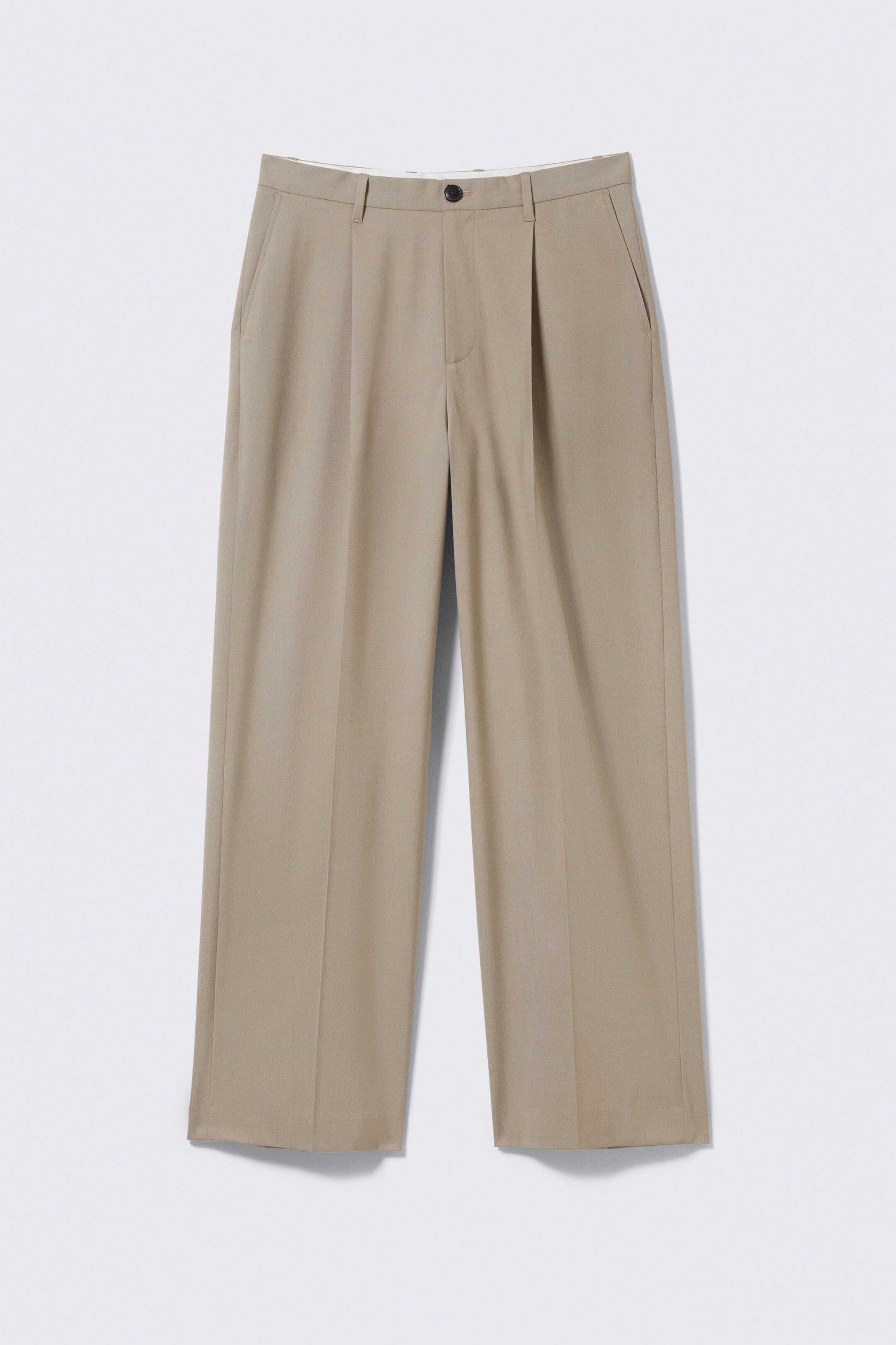 View larger image: The beige pleated pants are facing forward, featuring a single button closure, belt loops, and side slash pockets at the waist. Each wide leg is displaying a prominent central crease.