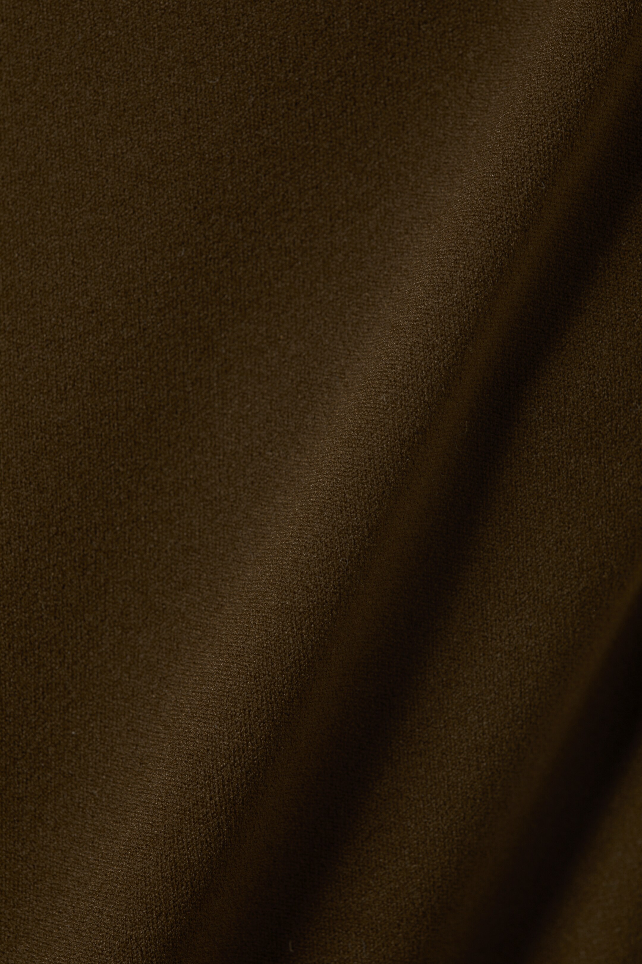 View larger image: A dark brown fabric is showing a subtle, textured surface. It is draping softly with gentle folds and shadows.