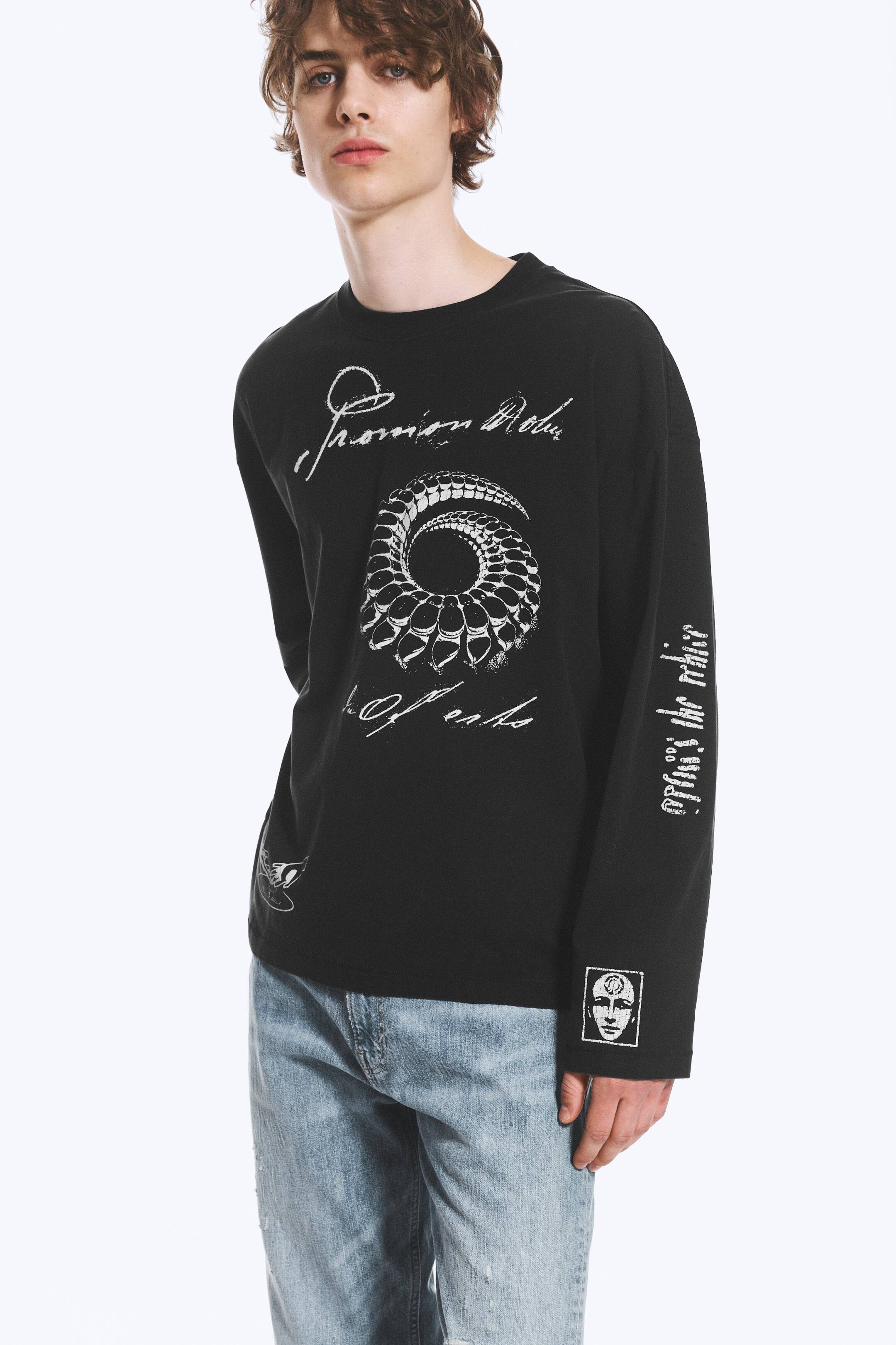 View larger image: A black long-sleeve T-shirt features a large white spiral graphic and white script text on the front. White script text runs vertically down the left sleeve, and a small square graphic depicting a face is located on the right sleeve cuff.