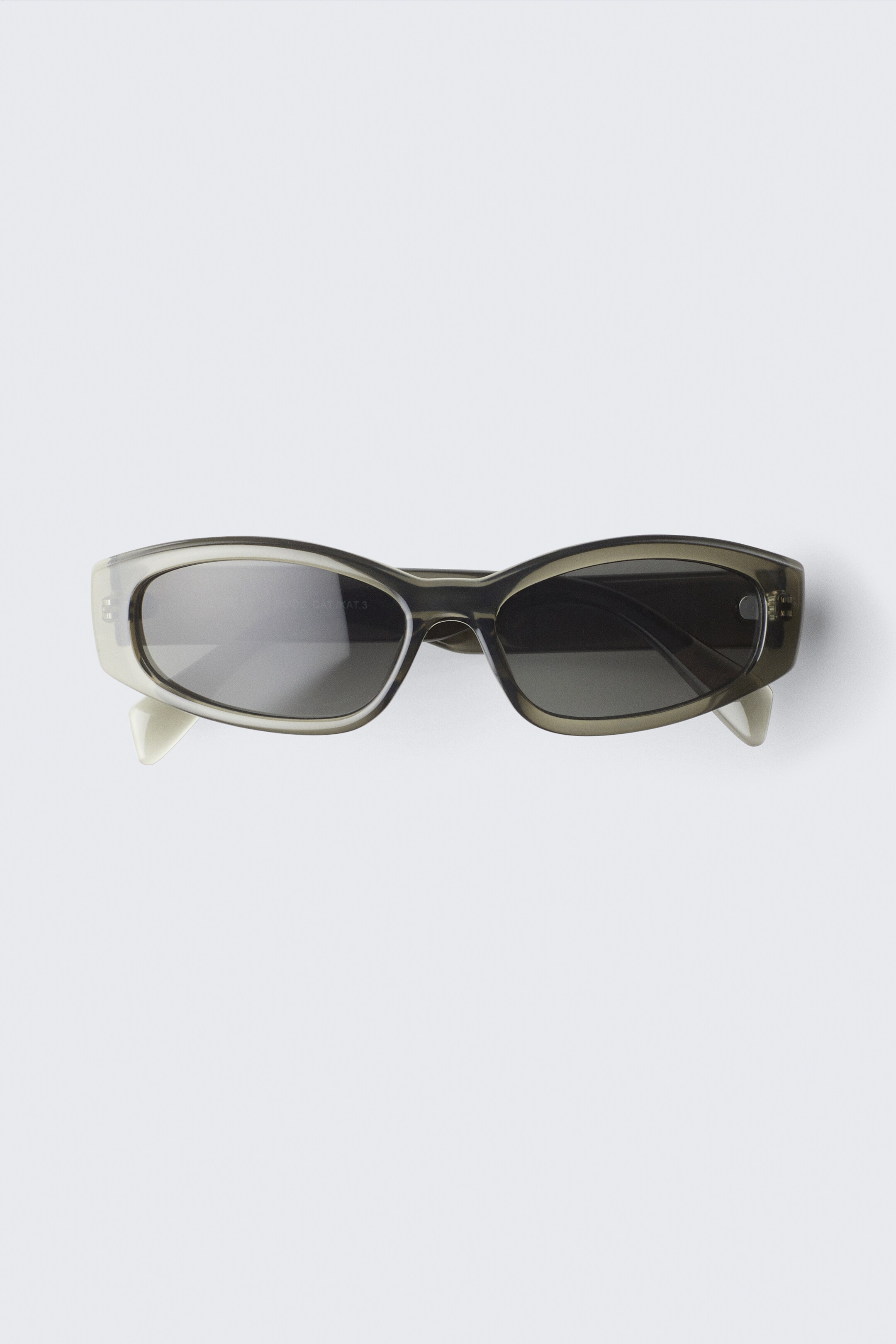 Visa större bild: Unisex solglasögon med böjd båge - Transparent Khaki - HERR | H&M SE 1
