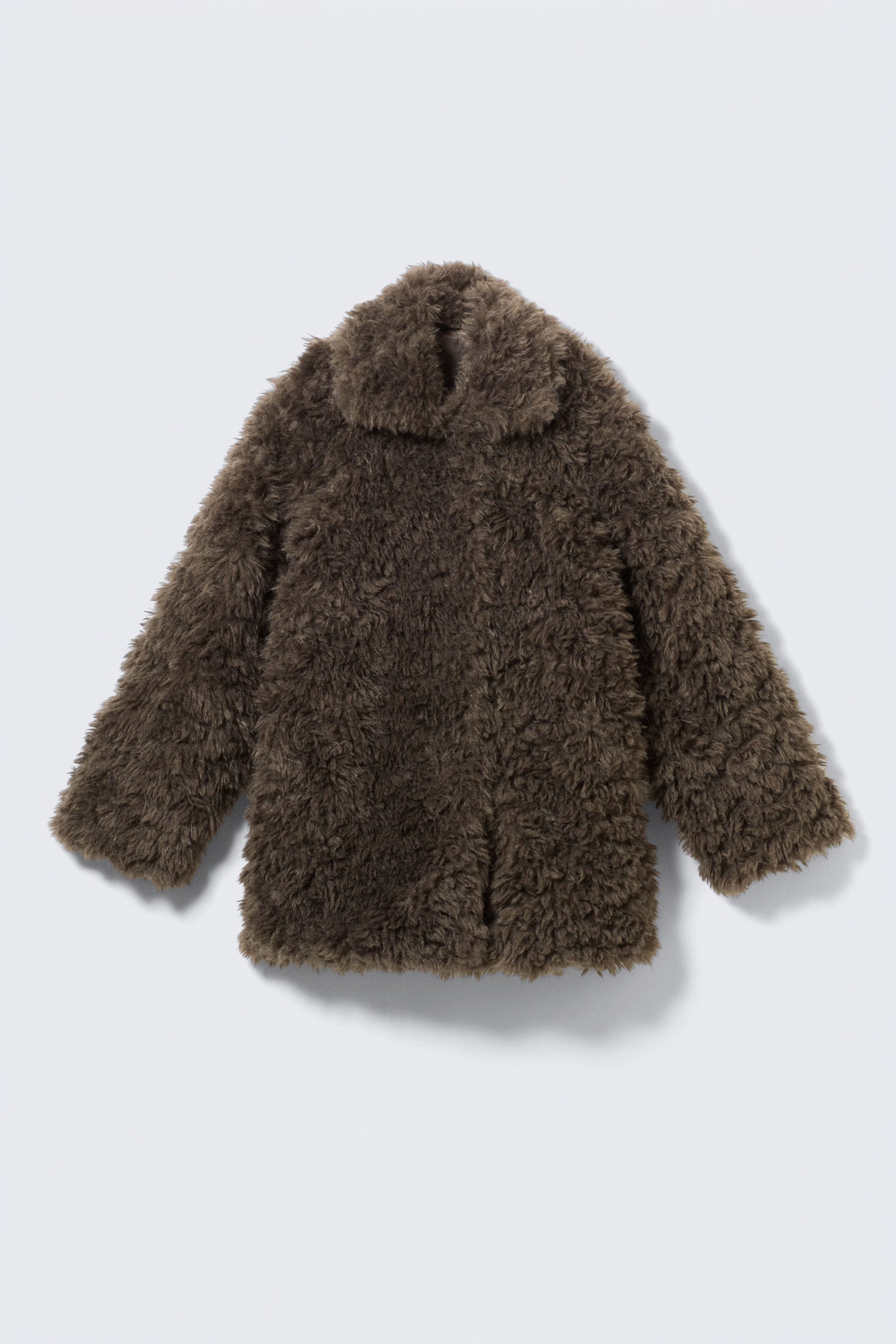 View larger image: A dark brown faux fur jacket is presenting FRONT, featuring a loose fit and a plush, shaggy texture. It is showcasing a large, open collar and side seam pockets subtly shifted forward.