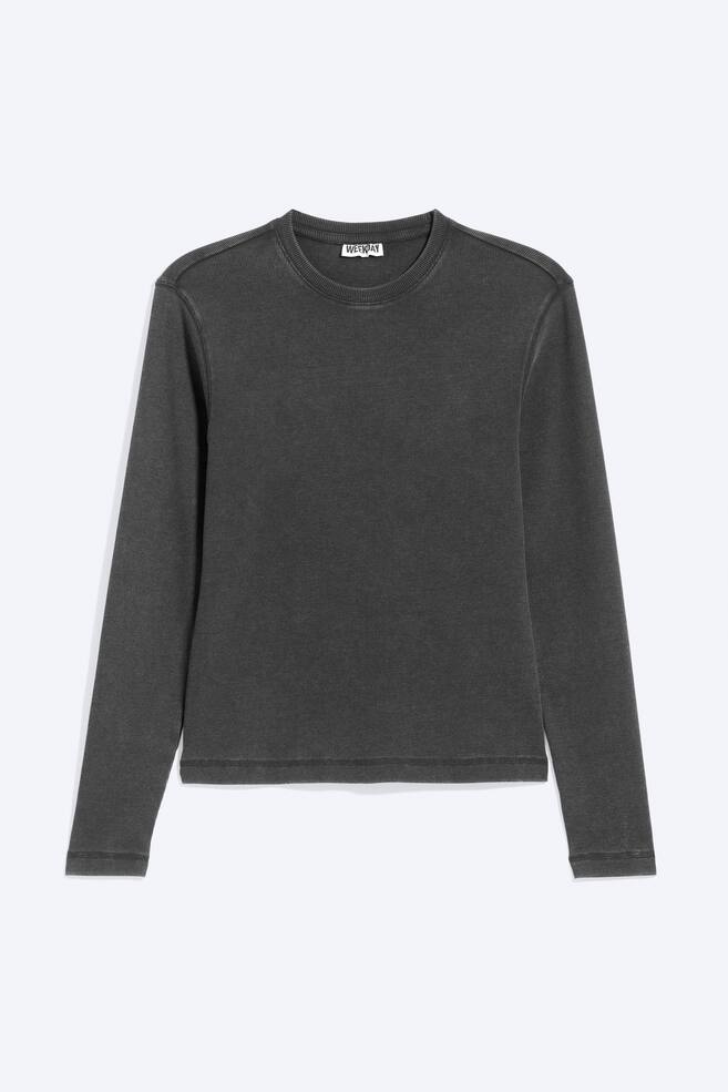 A dark grey, long-sleeved T-shirt made from ribbed cotton is shown from the front, featuring a crew neckline and a slim silhouette. The shirt has subtle flatlock stitching along the armholes, cuffs, and straight hem. - 1