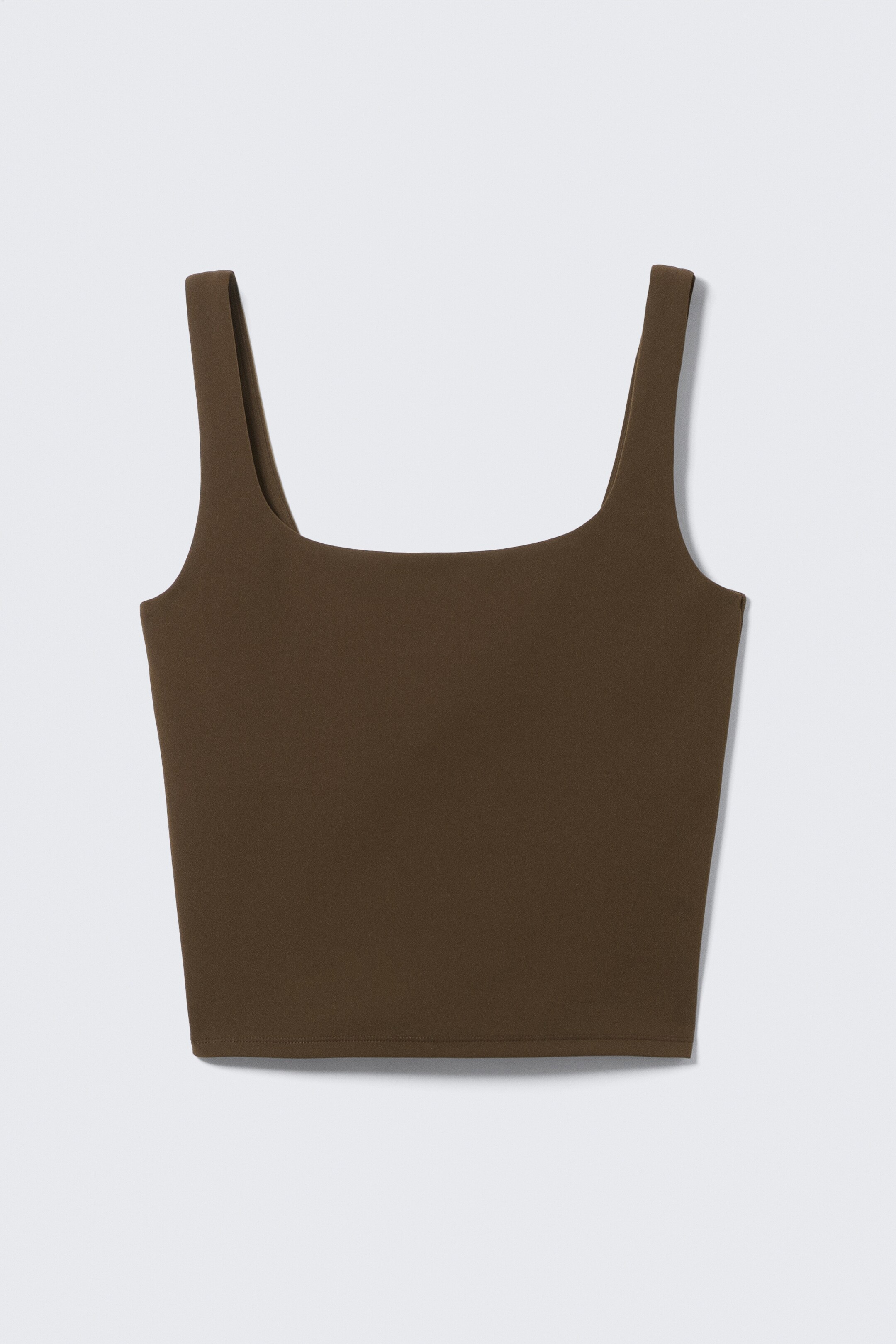View larger image: A dark brown cropped tank top is being shown from the front, featuring a square neckline, wide shoulder straps, and a straight hem.