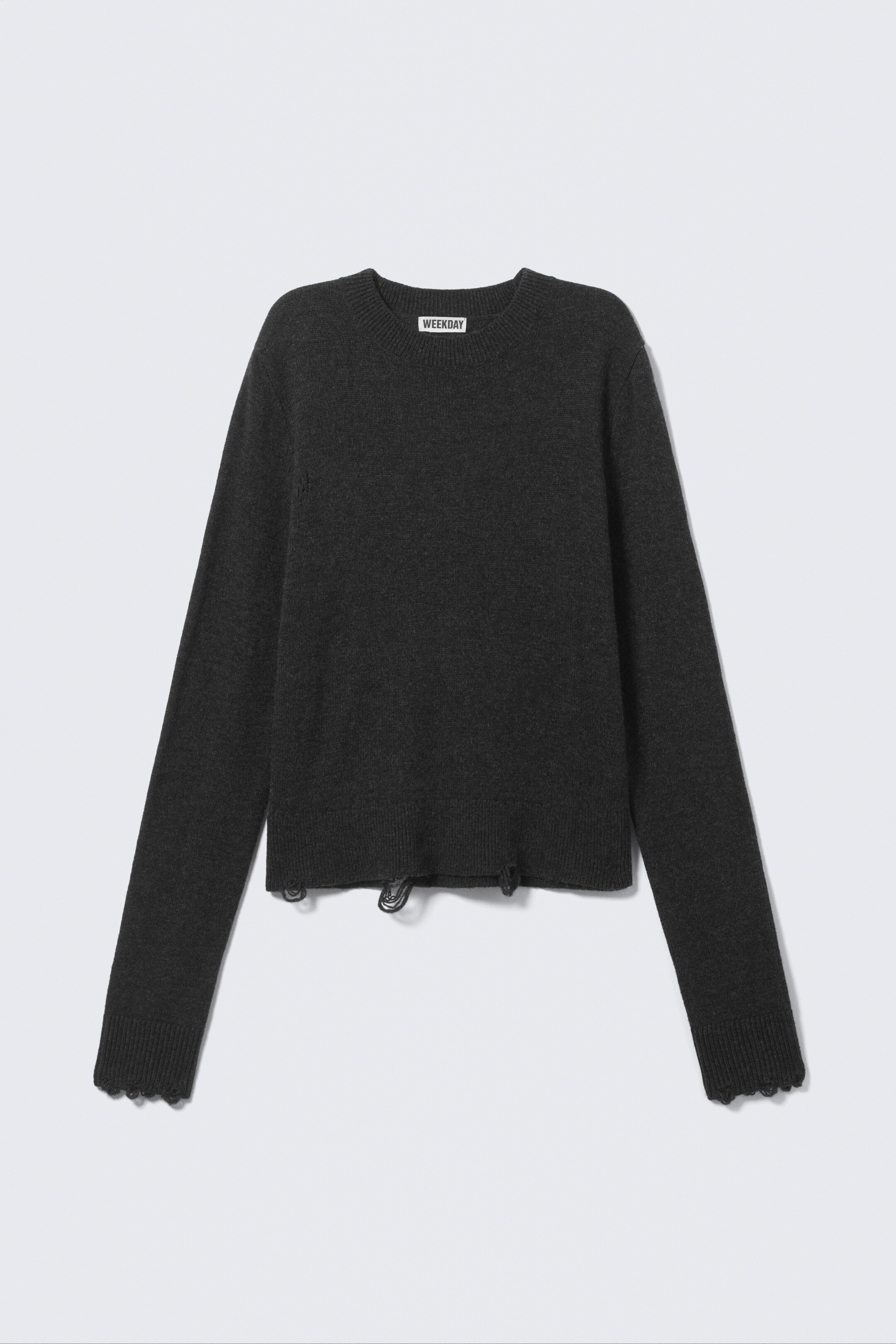 View larger image: A dark gray crew neck sweater is displaying its front, featuring long sleeves with distressed scalloped cuffs, a cropped hemline with visible ripped details, and a "WEEKDAY" brand tag at the inner neckline.