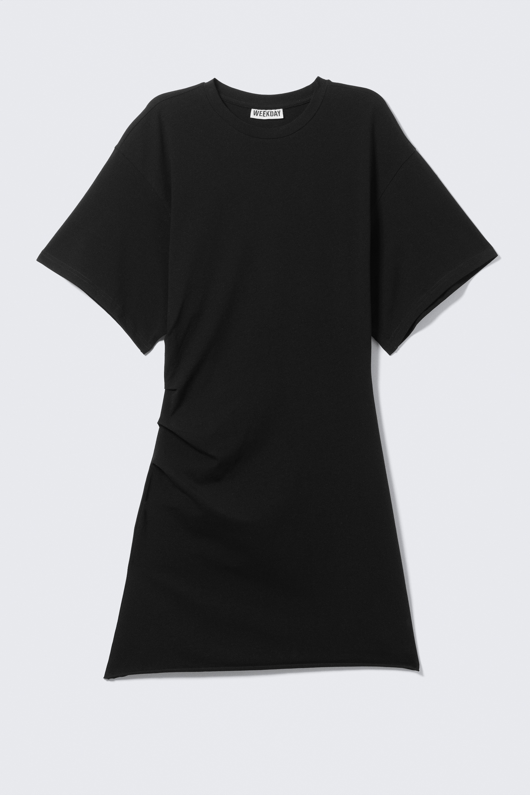 View larger image: FRONT. A black short T-shirt dress is displaying a cinched silhouette with placed pleats at the waist, creating a softly gathered effect. It is featuring short sleeves, a classic crew neckline, a raw-edge hem, and is crafted from stretchy cotton jersey, with a "WEEKDAY" label visible at the neckline.