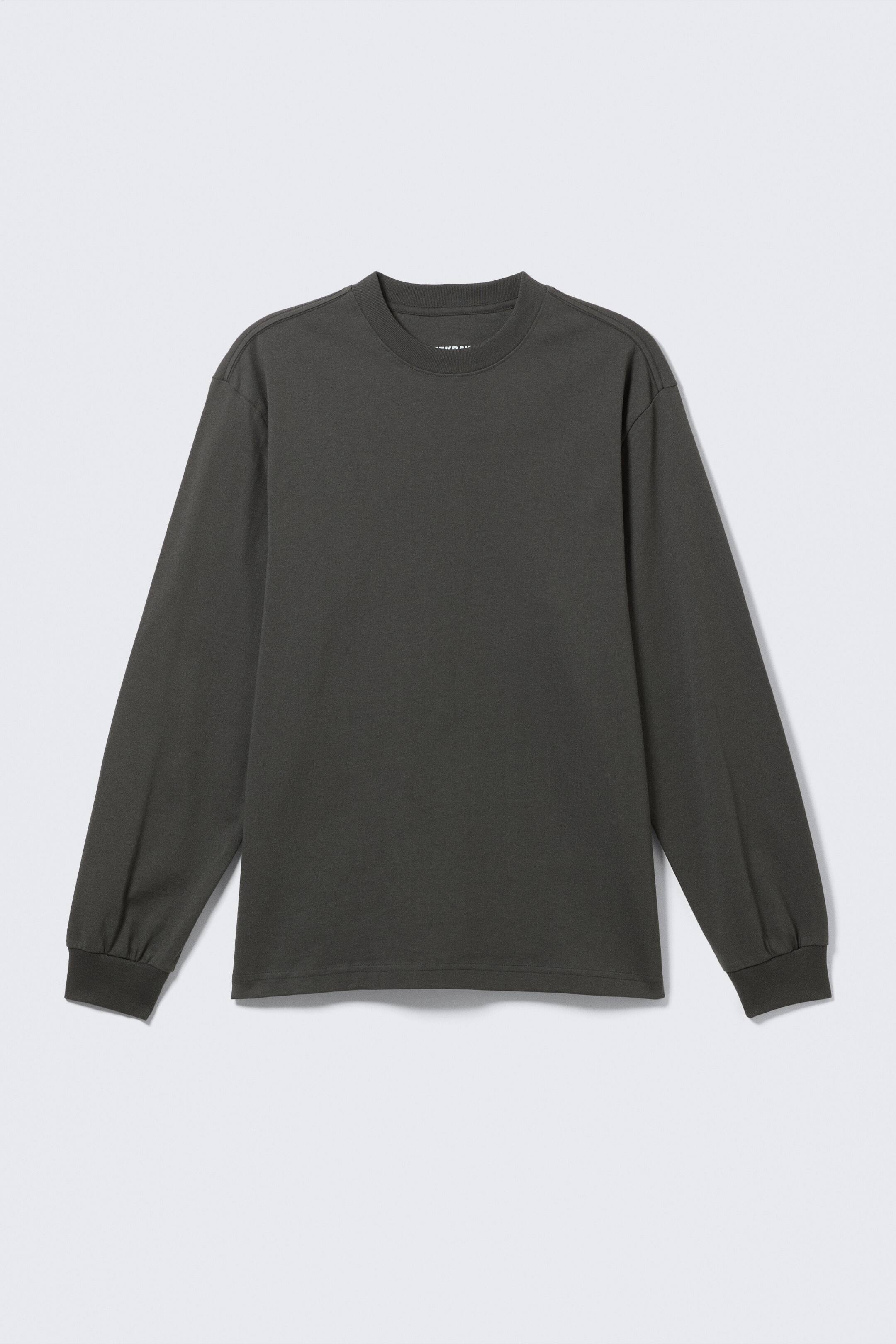 Ingrandisci l'immagine: Una t-shirt a maniche lunghe, di colore grigio scuro e vestibilità rilassata, in maglia jersey, presenta il suo DAVANTI. È progettata con uno scollo a girocollo a coste, spalle leggermente cadenti e maniche lunghe che terminano in polsini a coste.