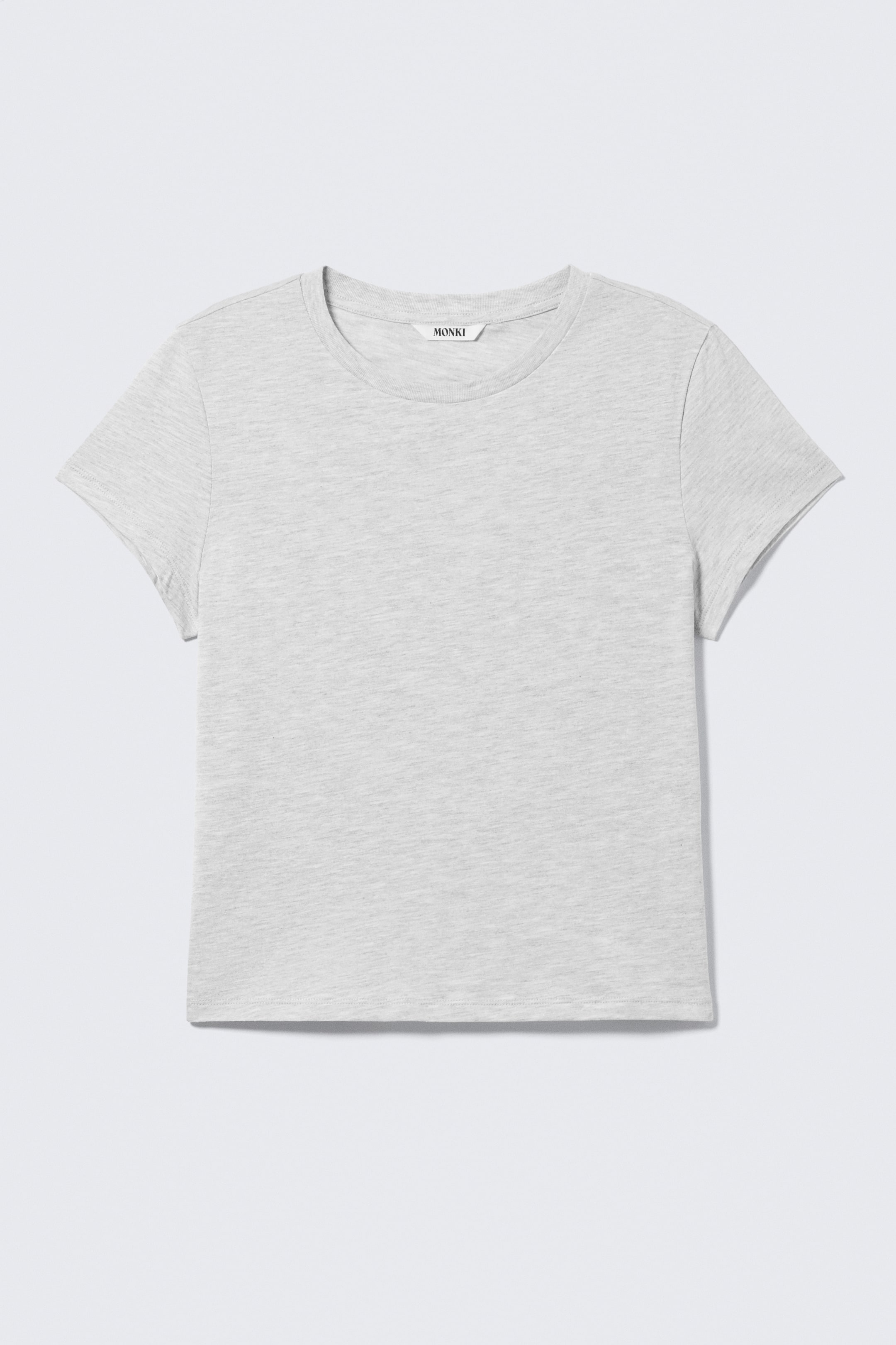 Ver imagen más grande: Una camiseta jaspeada de color gris claro se presenta desde el frente, con cuello redondo, mangas cortas y una etiqueta visible de "MONKI" en la parte trasera del cuello.