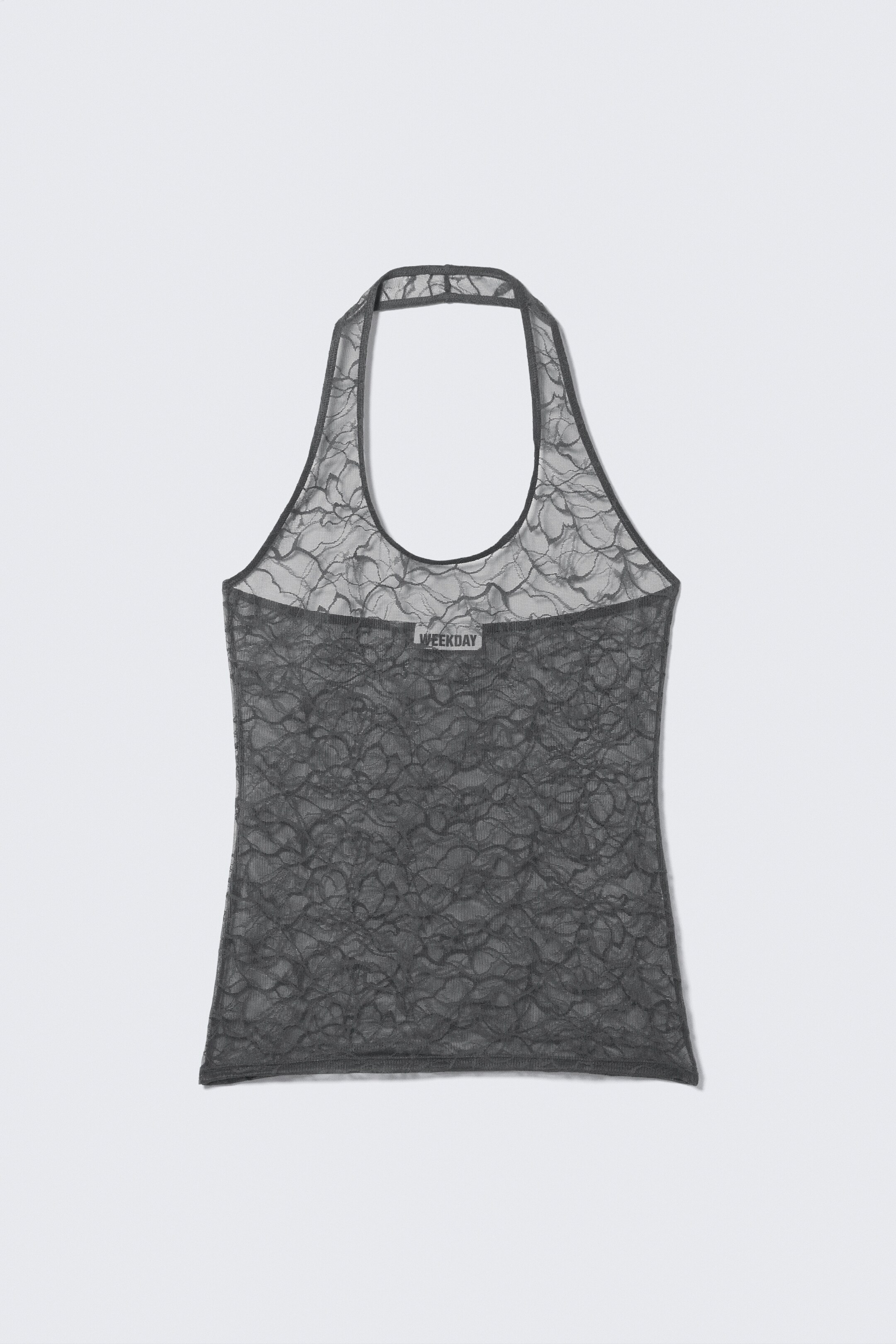 Agrandir l'image: Un haut à col licou gris foncé est orienté vers l'avant, avec une superposition en dentelle transparente avec un motif floral. Une étiquette « WEEKDAY » est visible sur une section côtelée au niveau du haut du dos.