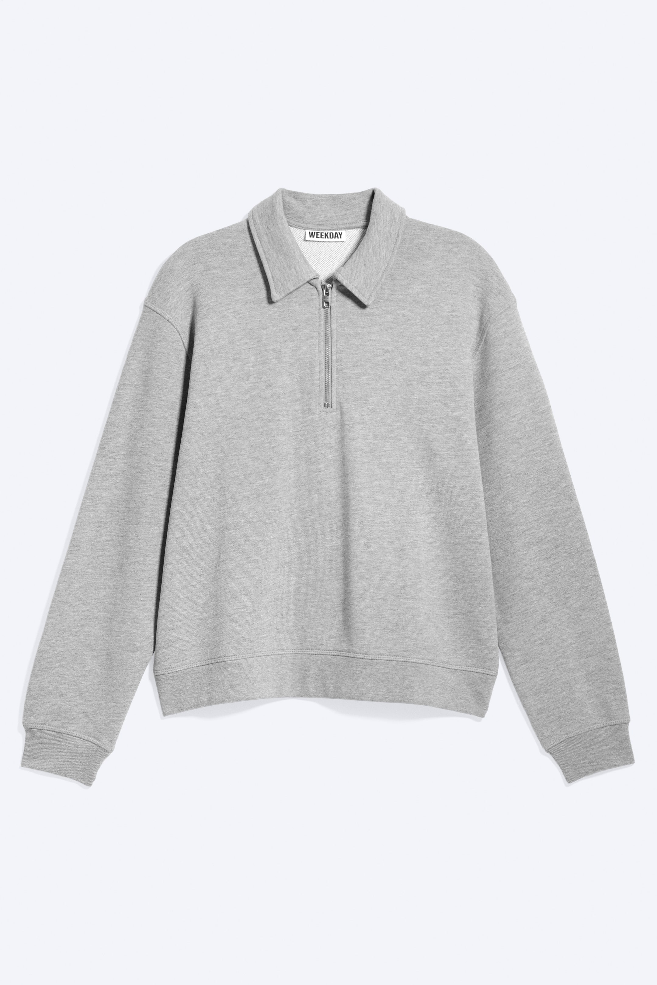 View larger image: A grey sweatshirt is shown from the front, featuring a polo collar and a quarter-zip opening with a silver-toned zip. It is designed with long sleeves, ribbed cuffs, and a ribbed hem.