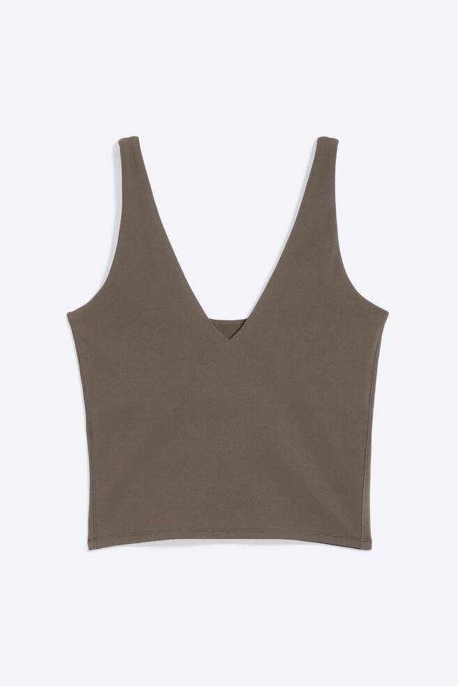 A taupe cropped top is displayed facing front, featuring a plunging V-neckline, wide shoulder straps, a slim fit, and a straight cropped hem. - 1
