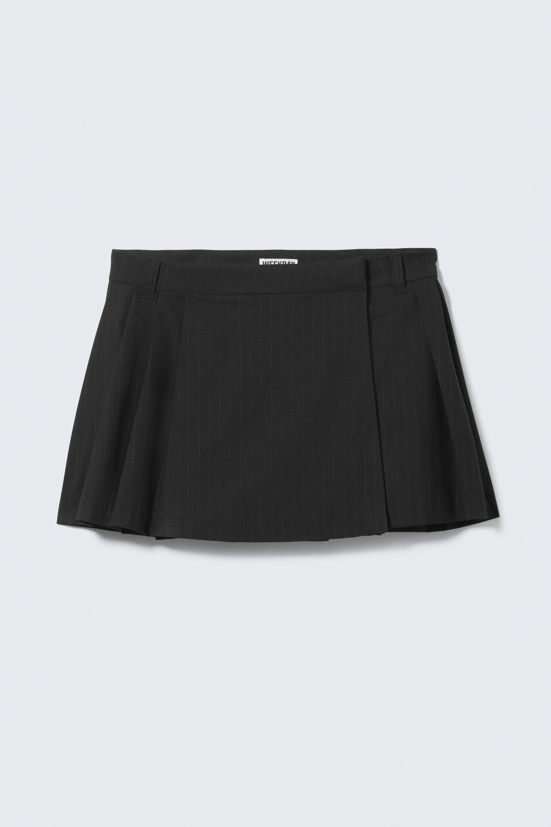 View larger image: A black pinstriped mini-skirt is presented from the front, featuring a flat waistband with belt loops and a subtly flared A-line silhouette.