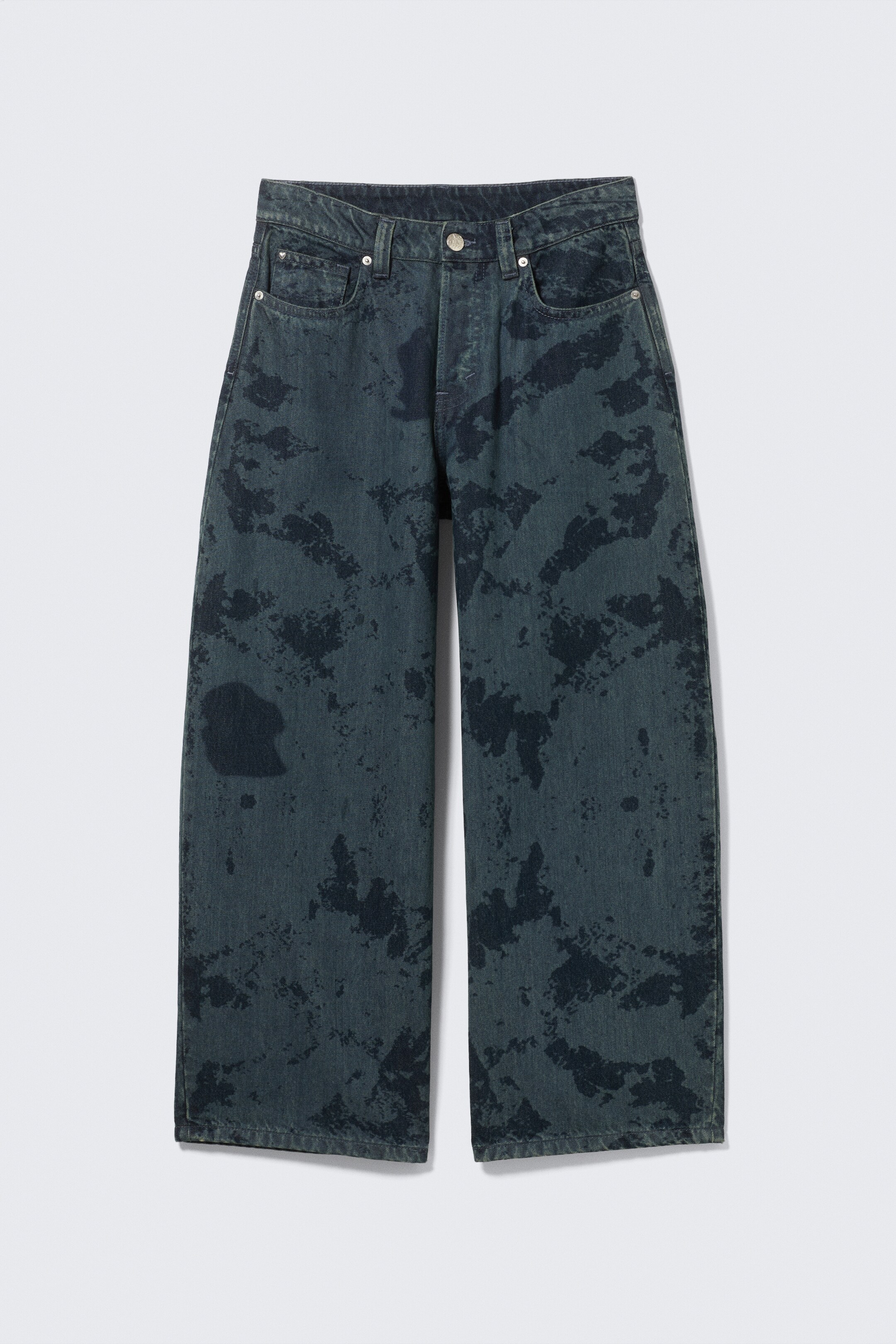 View larger image: A pair of low-rise jeans with a loose fit and super baggy leg are being shown from the front. They are featuring a dark blue base color with an irregular, lighter faded pattern throughout, a classic five-pocket design, and a button and zip fly closure.