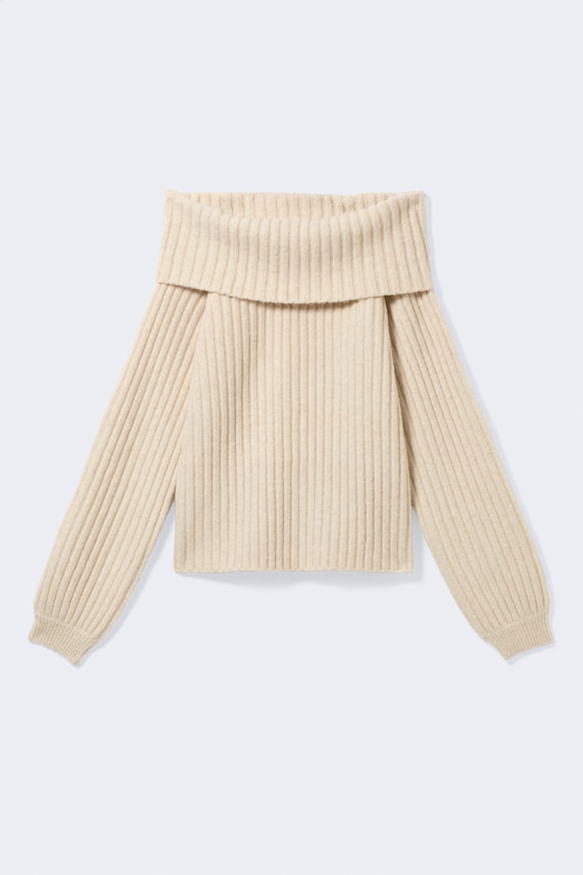 A cream-coloured ribbed knit jumper is shown facing front, featuring a wide, folded-over off-the-shoulder collar. The garment has long, relaxed raglan sleeves with ribbed cuffs and a straight hem. - 1