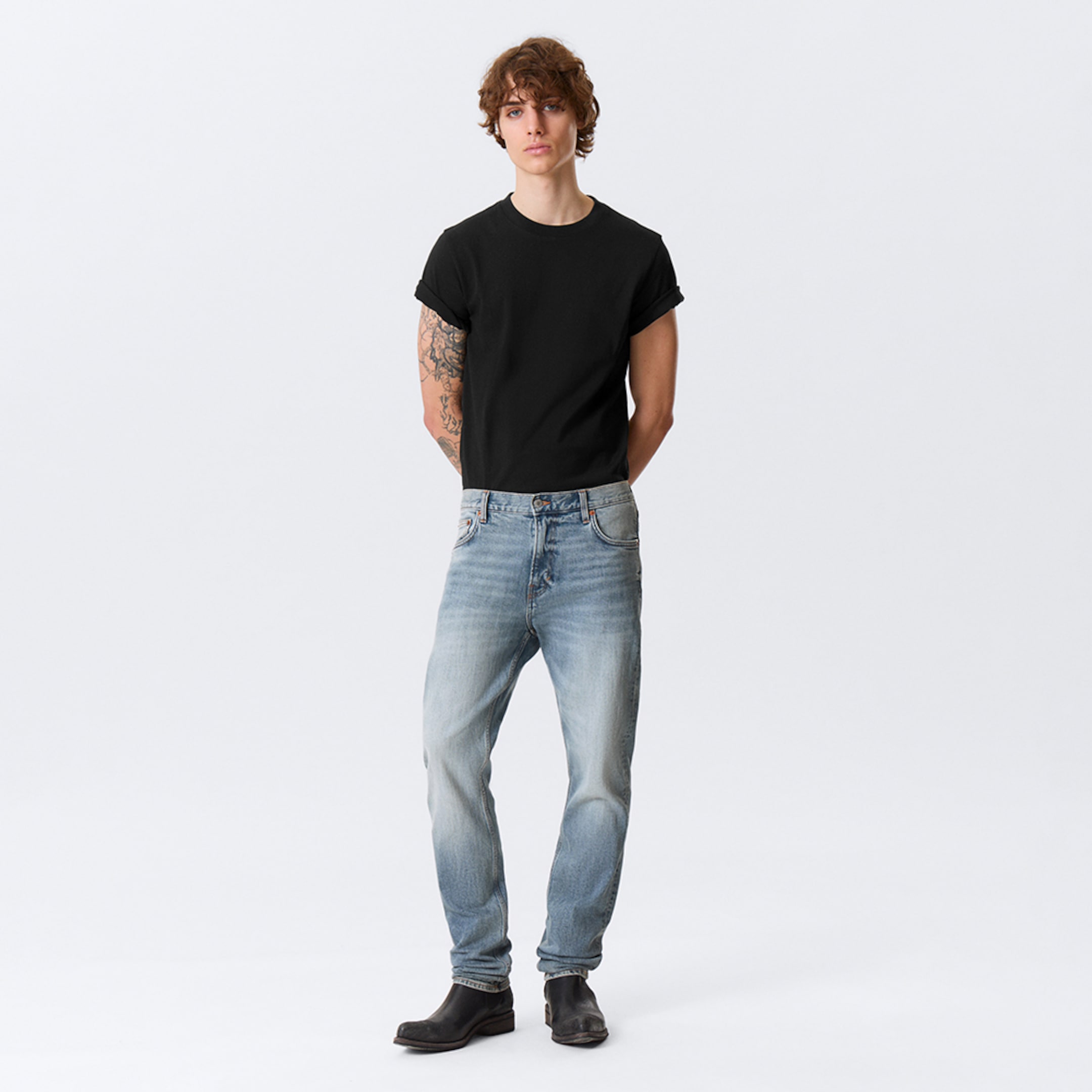 Model wearing a pair of slim fit jeans