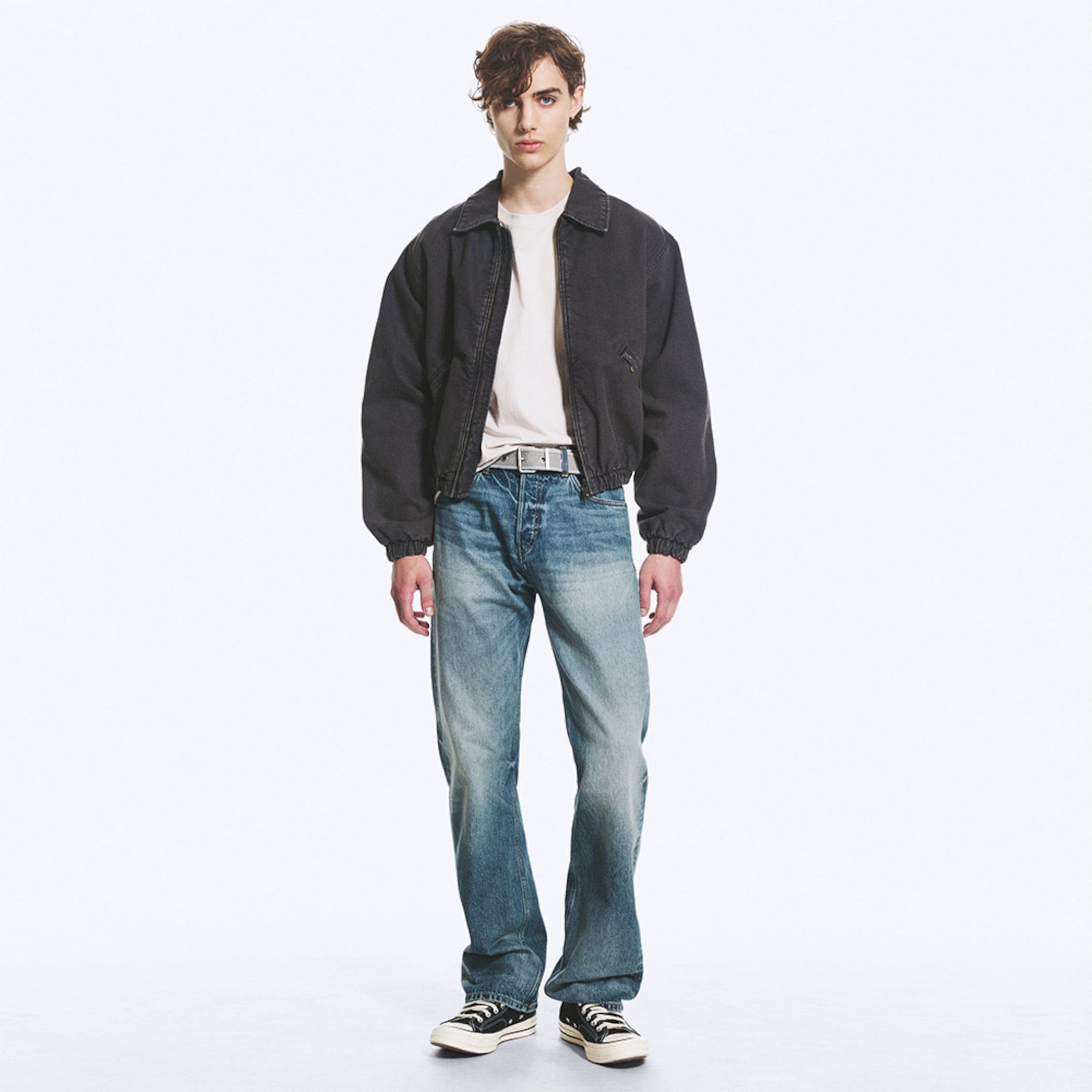 Model wearing a pair of relaxed fit jeans
