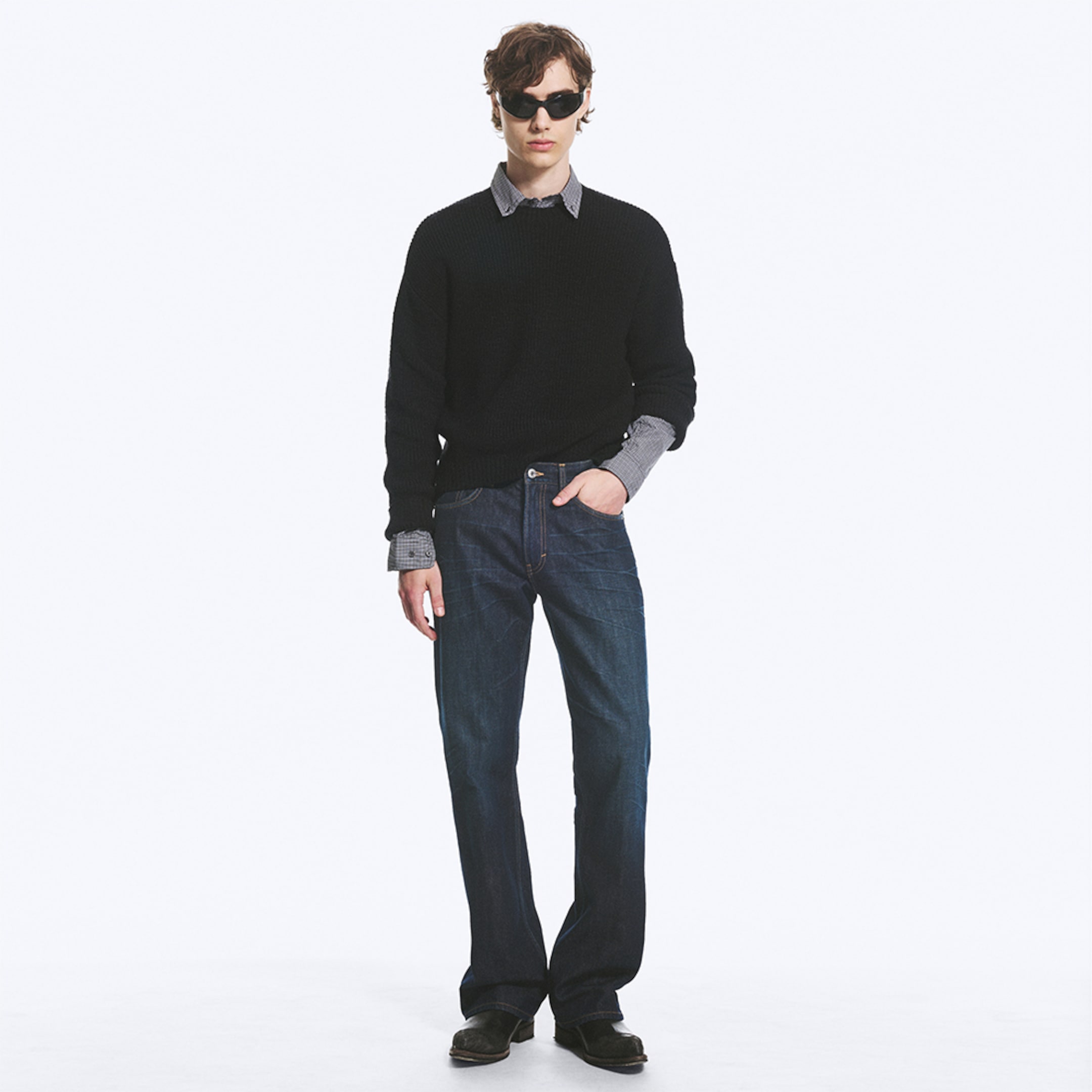 Model wearing a pair of bootcut fit jeans