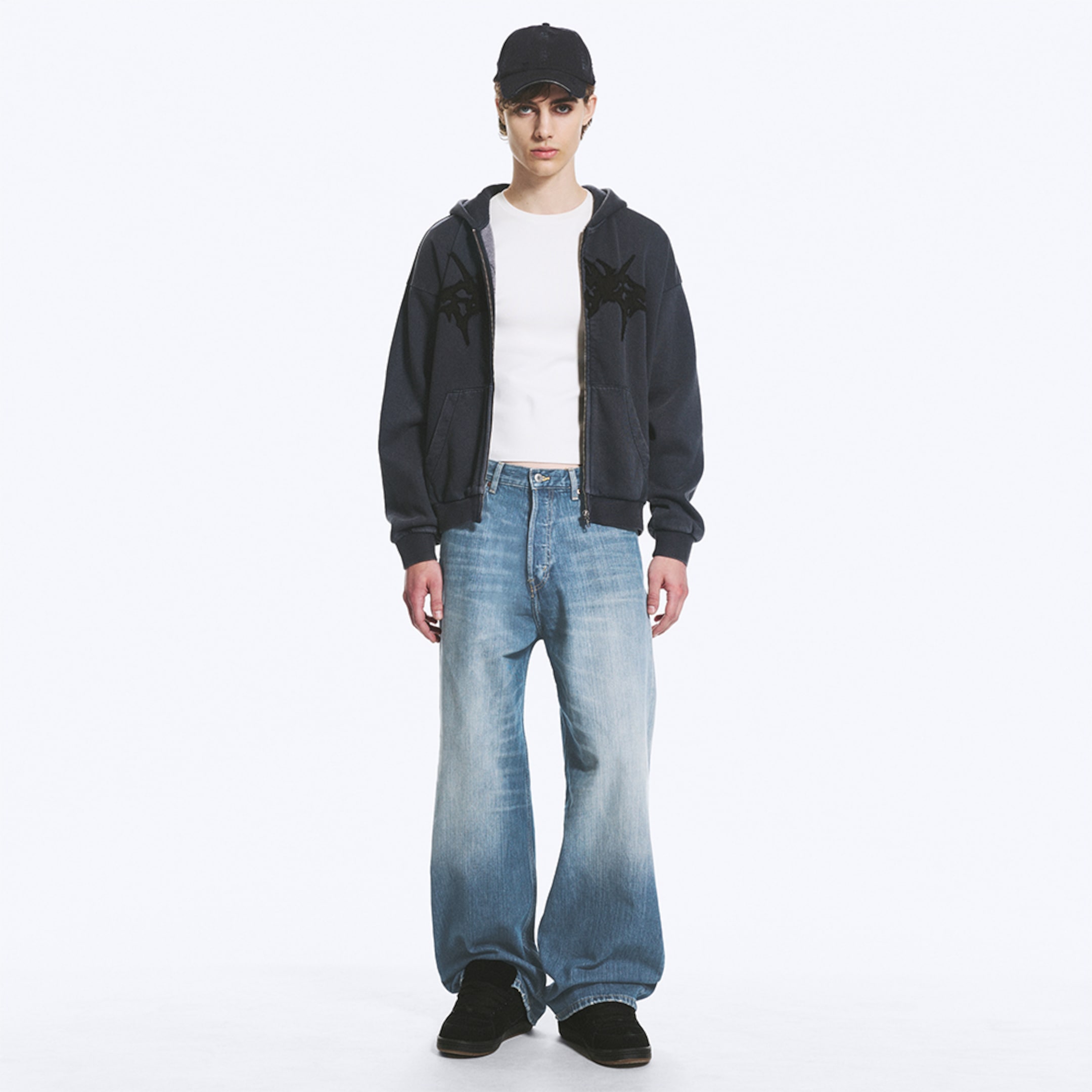 Model wearing a pair of loose fit jeans
