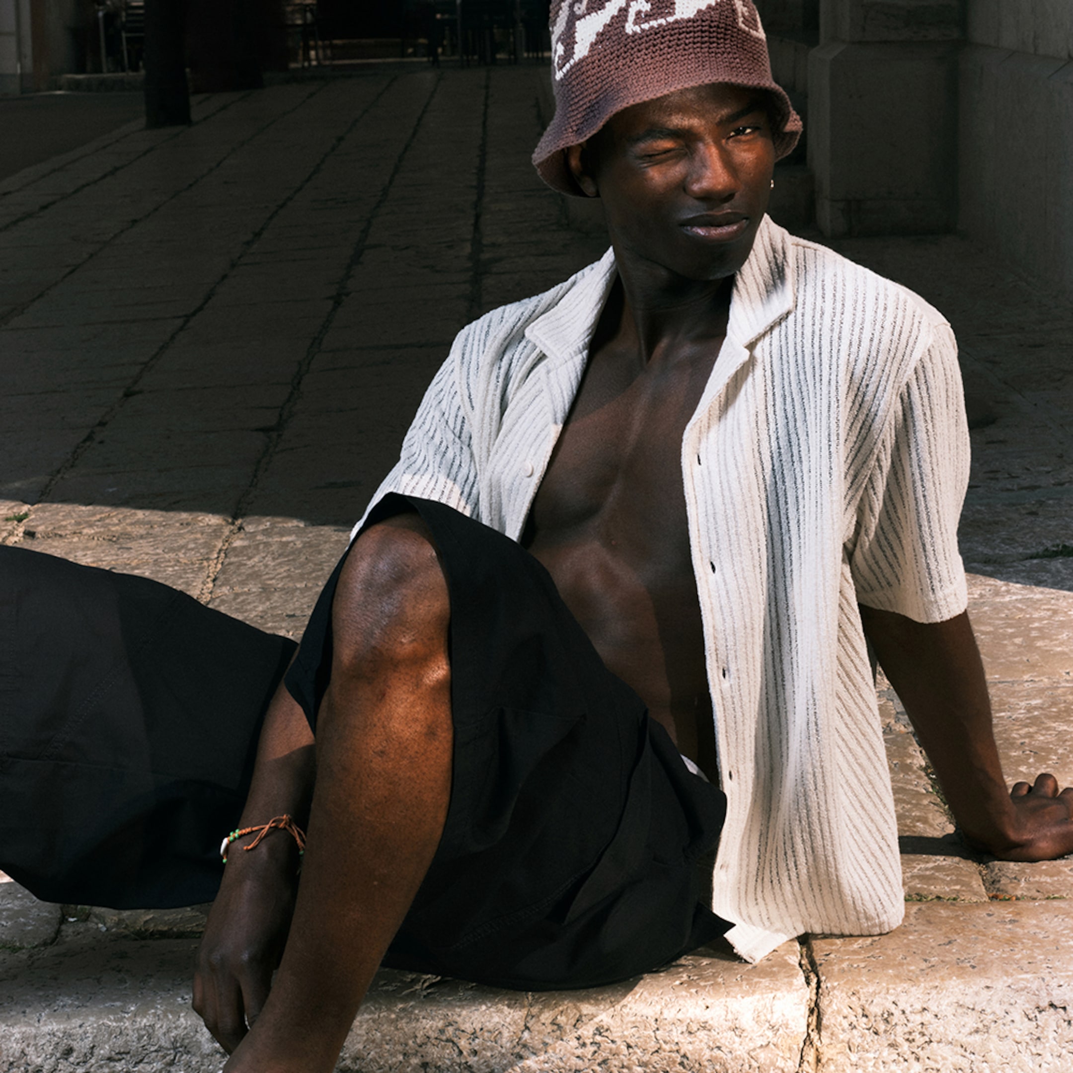 Model wearing a light yellow seersucker shirt paired with a pair of Weekday Jorts
