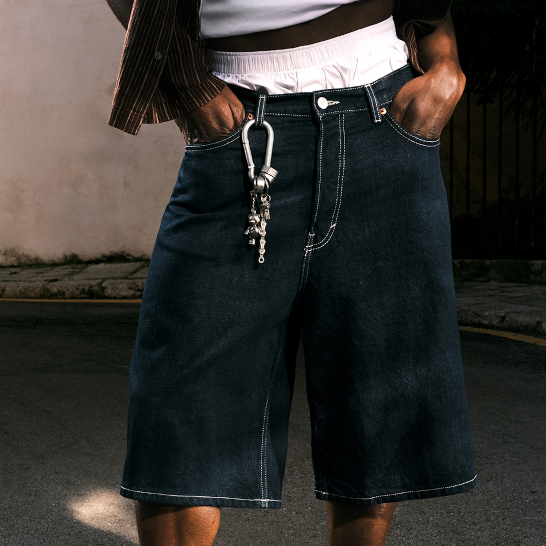 Model wearing a pair of blue rinse Astro Baggy Shorts