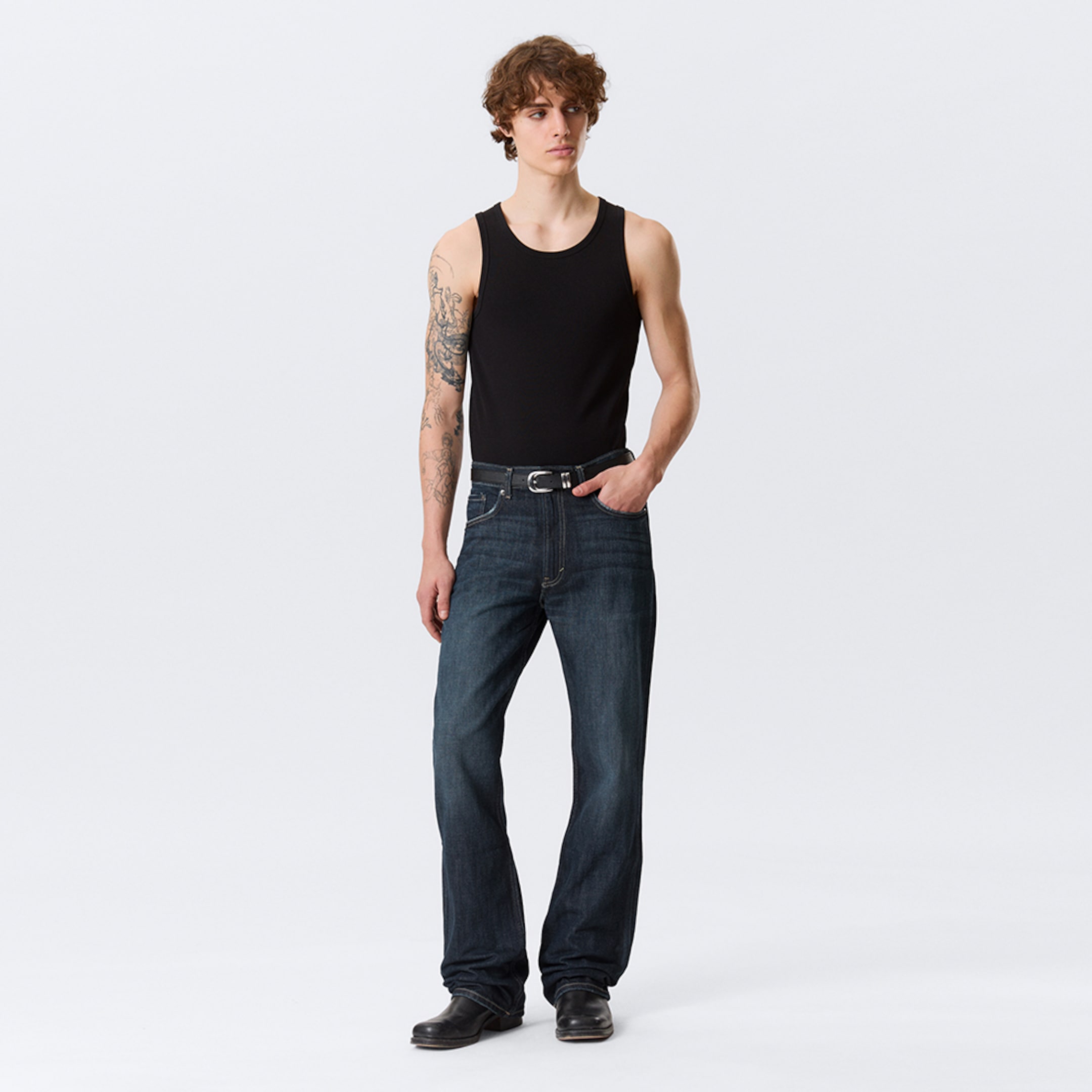 Model wearing a pair of bootcut fit jeans