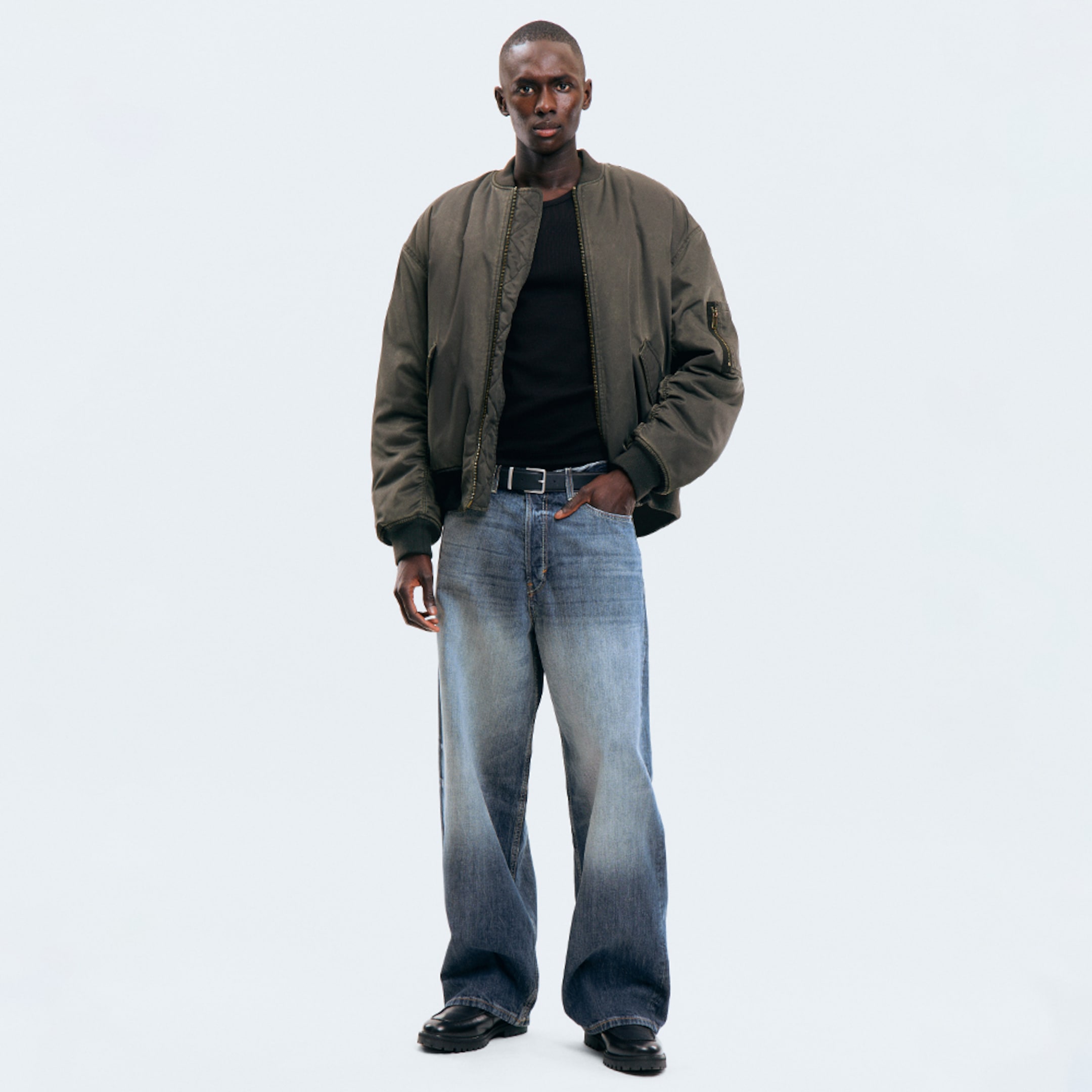 Model wearing a pair of loose fit jeans