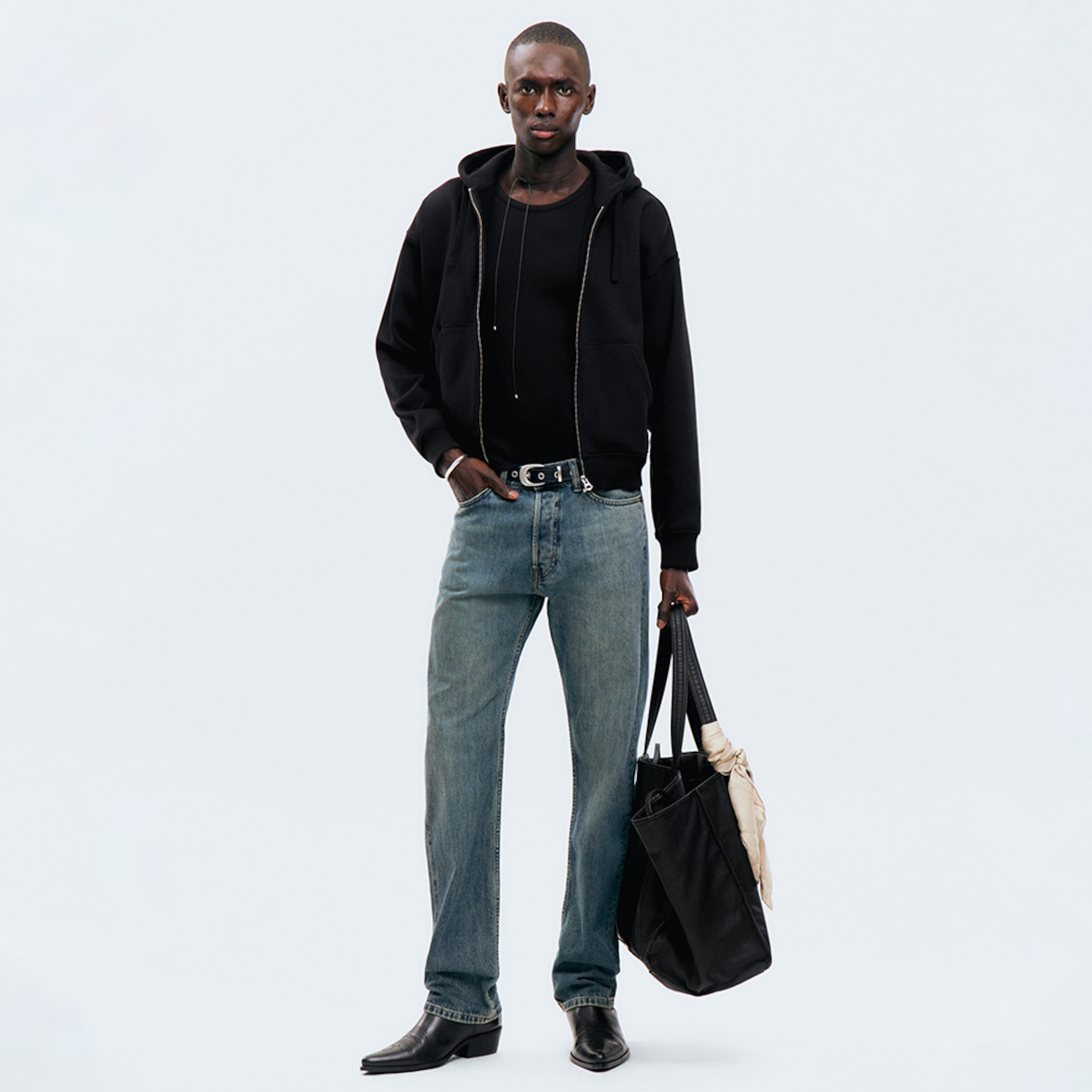 Model wearing a pair of relaxed fit jeans