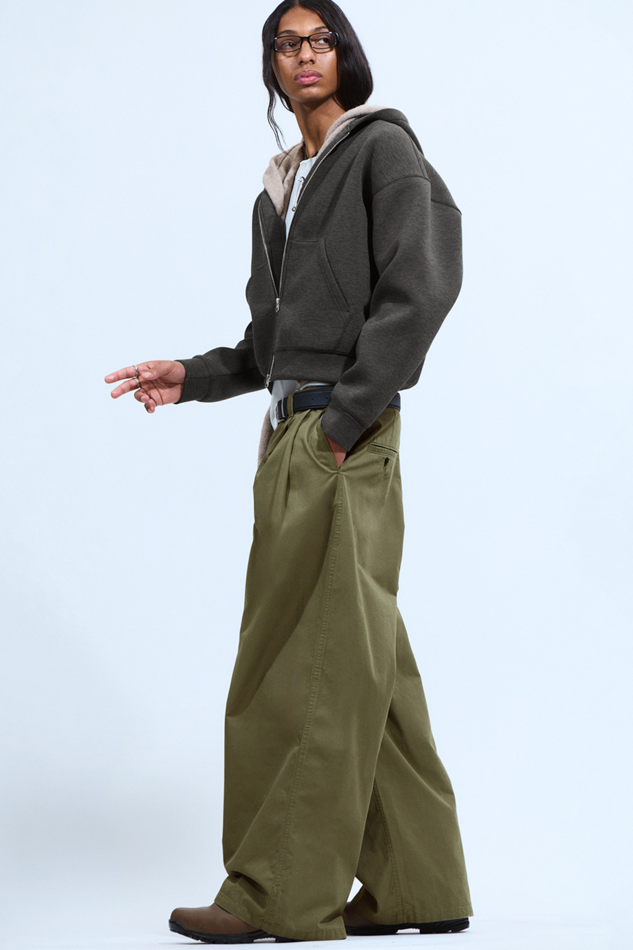 Model wearing a simon scuba zip hoodie paired with a pair of green loose fit trousers