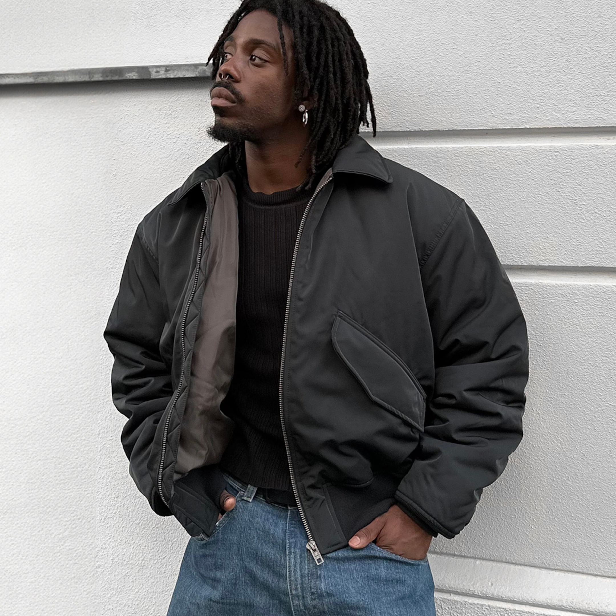 Model wearing a black oversized bomber jacket
