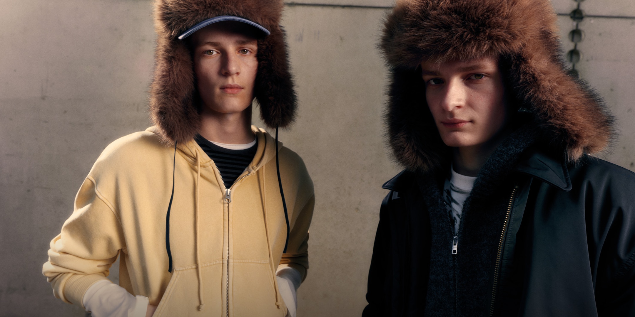 Two twing wearing fur hats and clothing from Weekday 2025 Fall collection