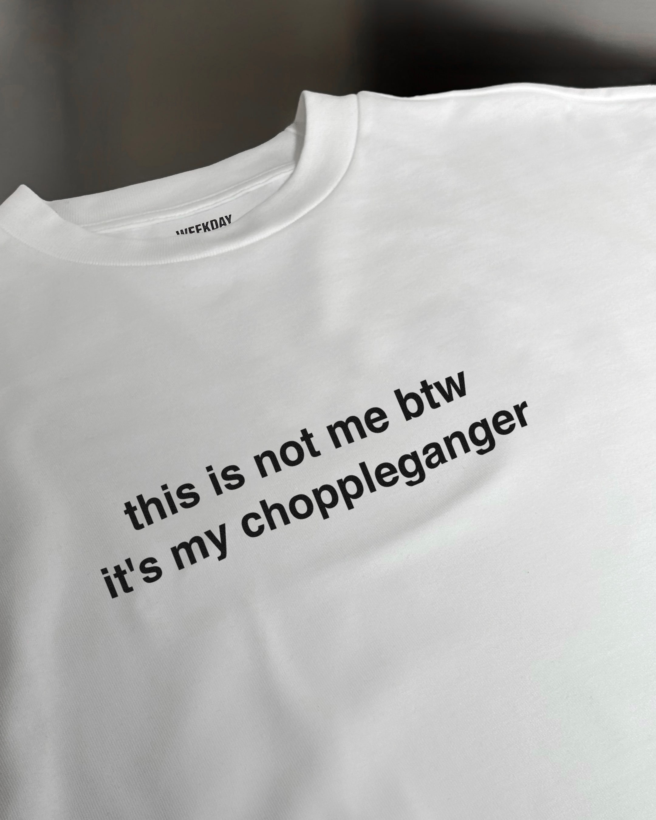 A person wearing a printed white Zeitgeist t-shirt saying “Sorry I missed your call. I was watching it ring till it stopped.”